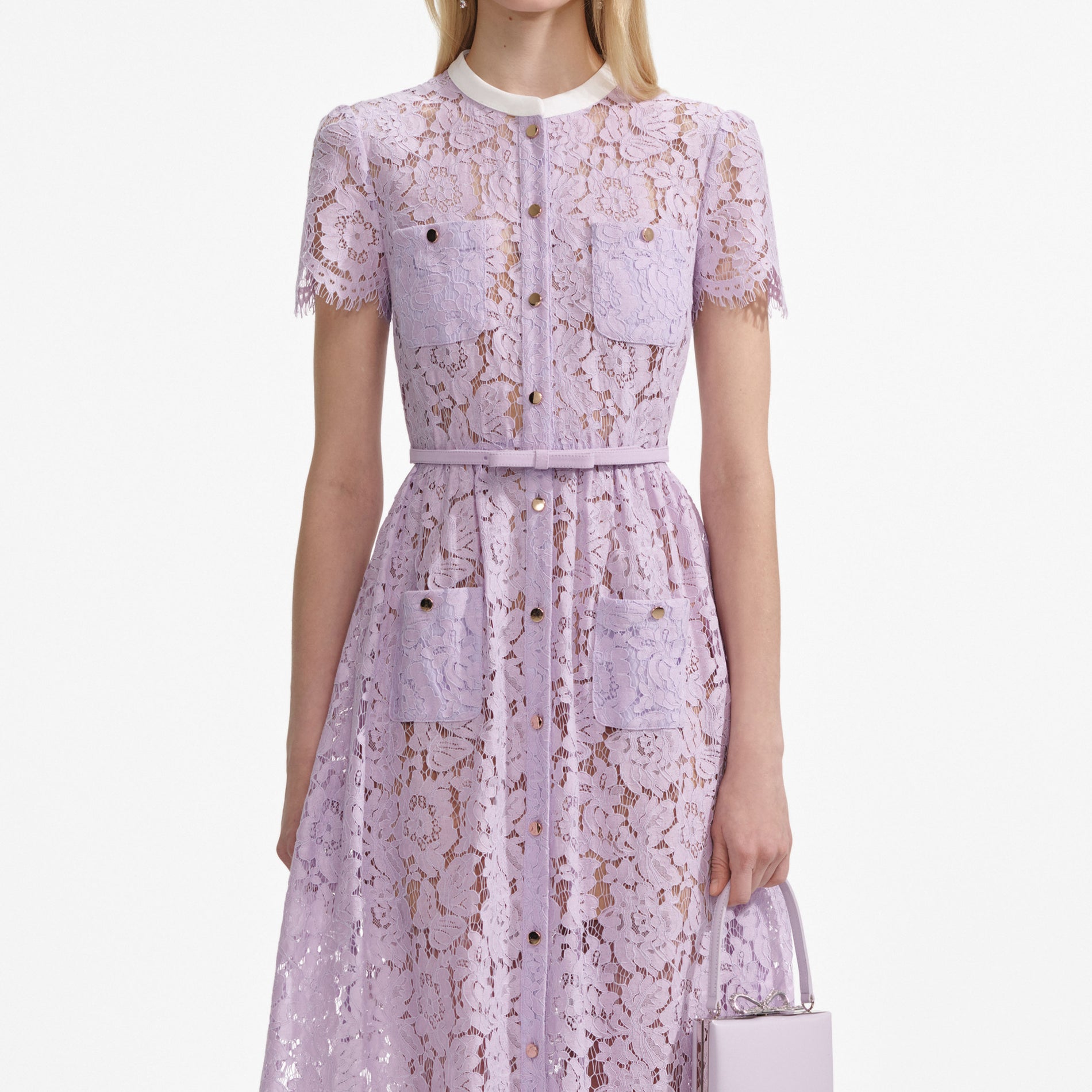 A close up of a woman wearing the Lilac Lace Button Front Midi Dress