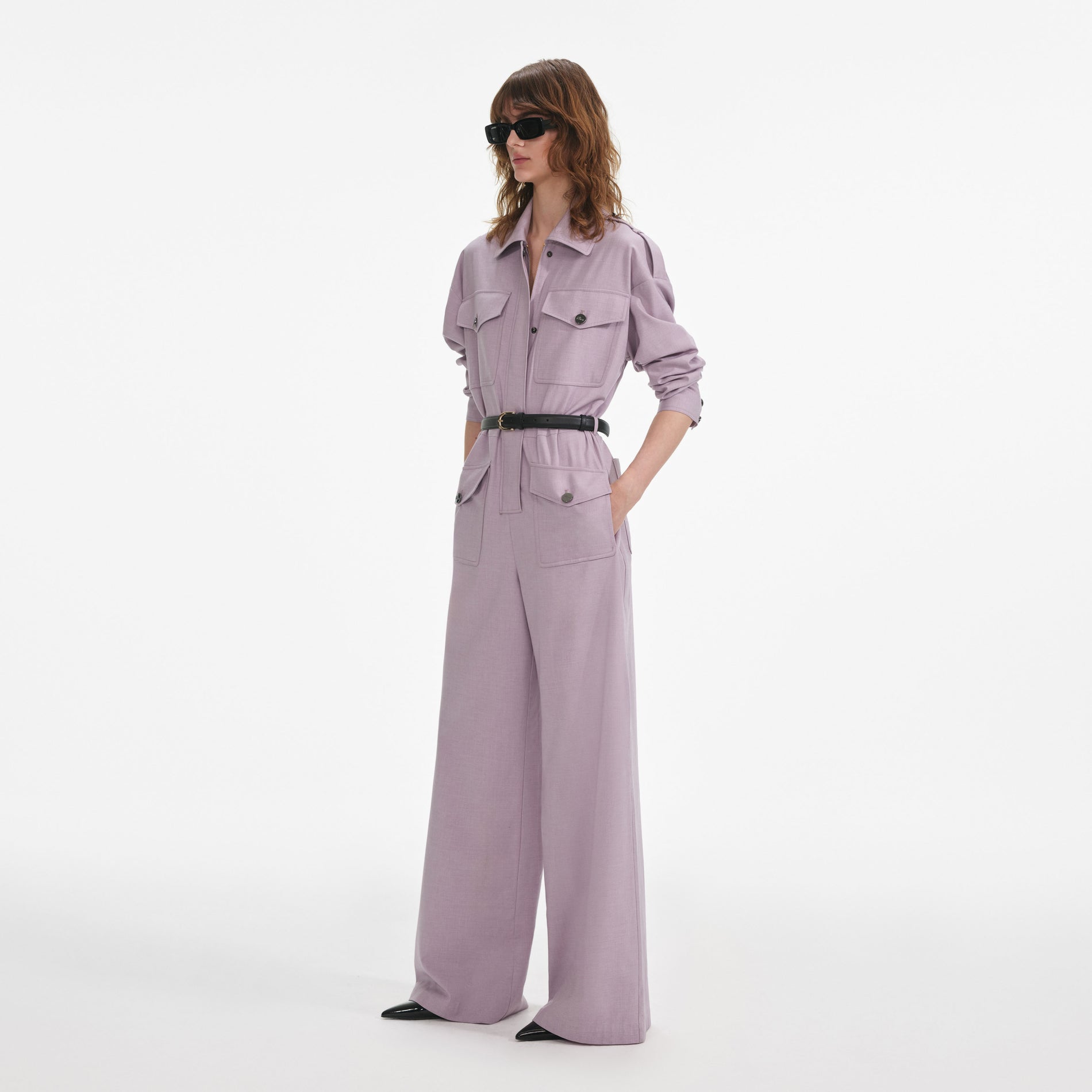 Side view of a woman wearing the Lilac Twill Jumpsuit