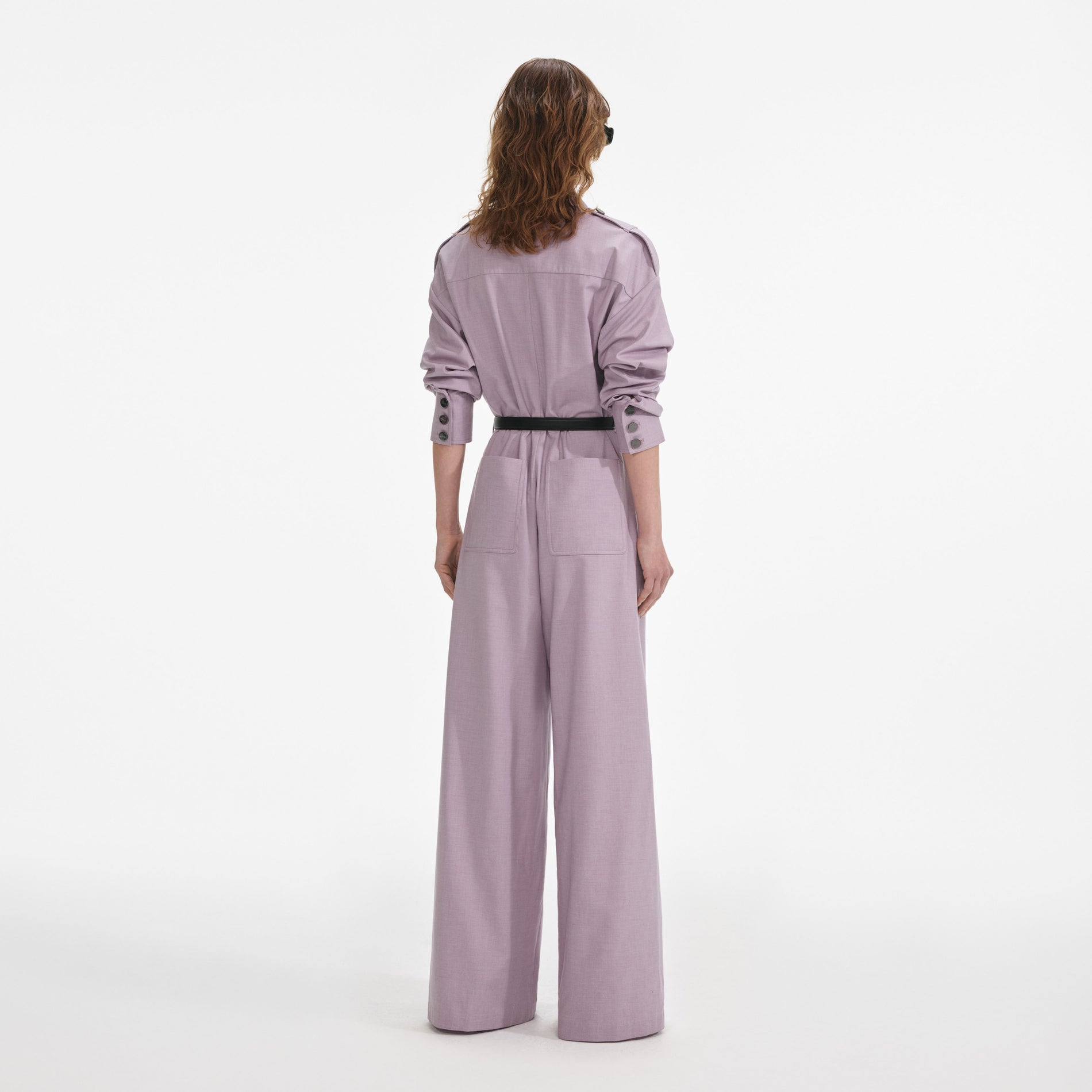 Back view of a woman wearing the Lilac Twill Jumpsuit