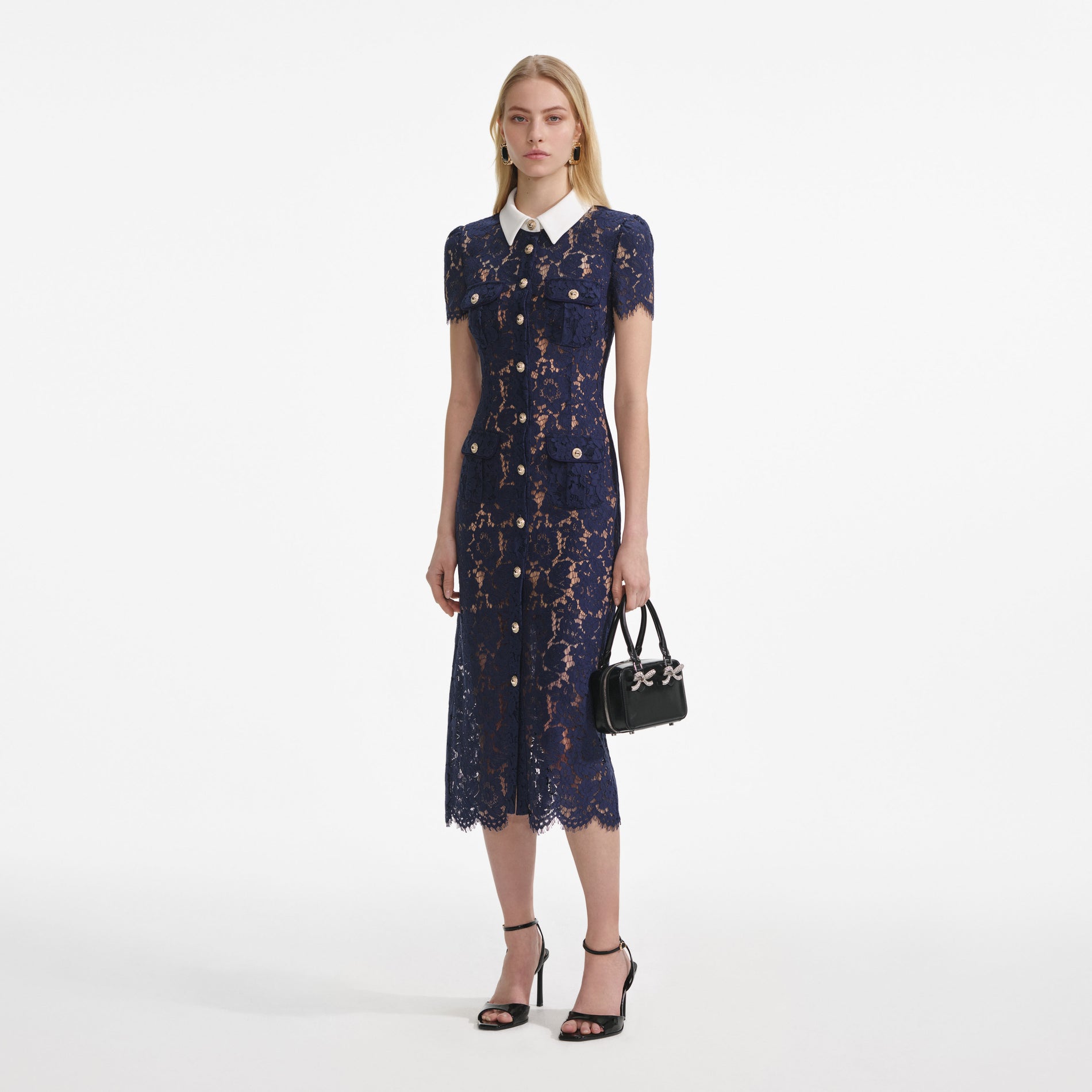 Side view of a woman wearing the Navy Lace Contrast Collar Midi Dress
