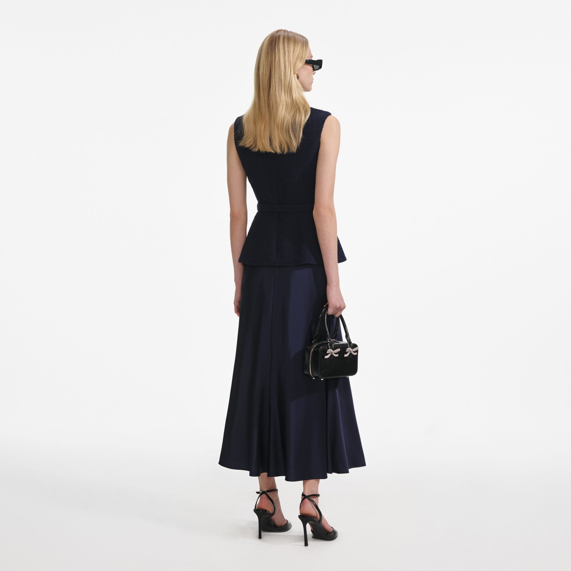 Back view of a woman wearing the Navy Boucle Sleeveless Midi Dress