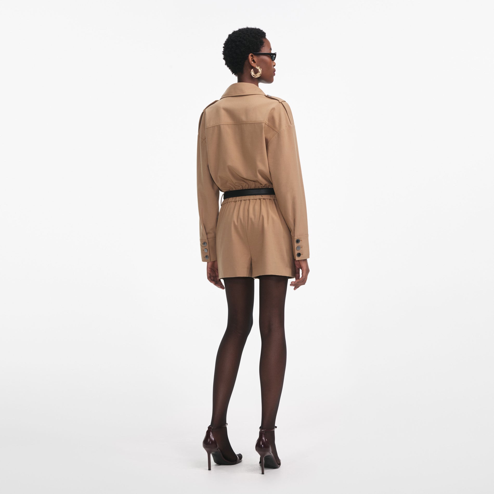 Back view of a woman wearing the Tan Twill Playsuit