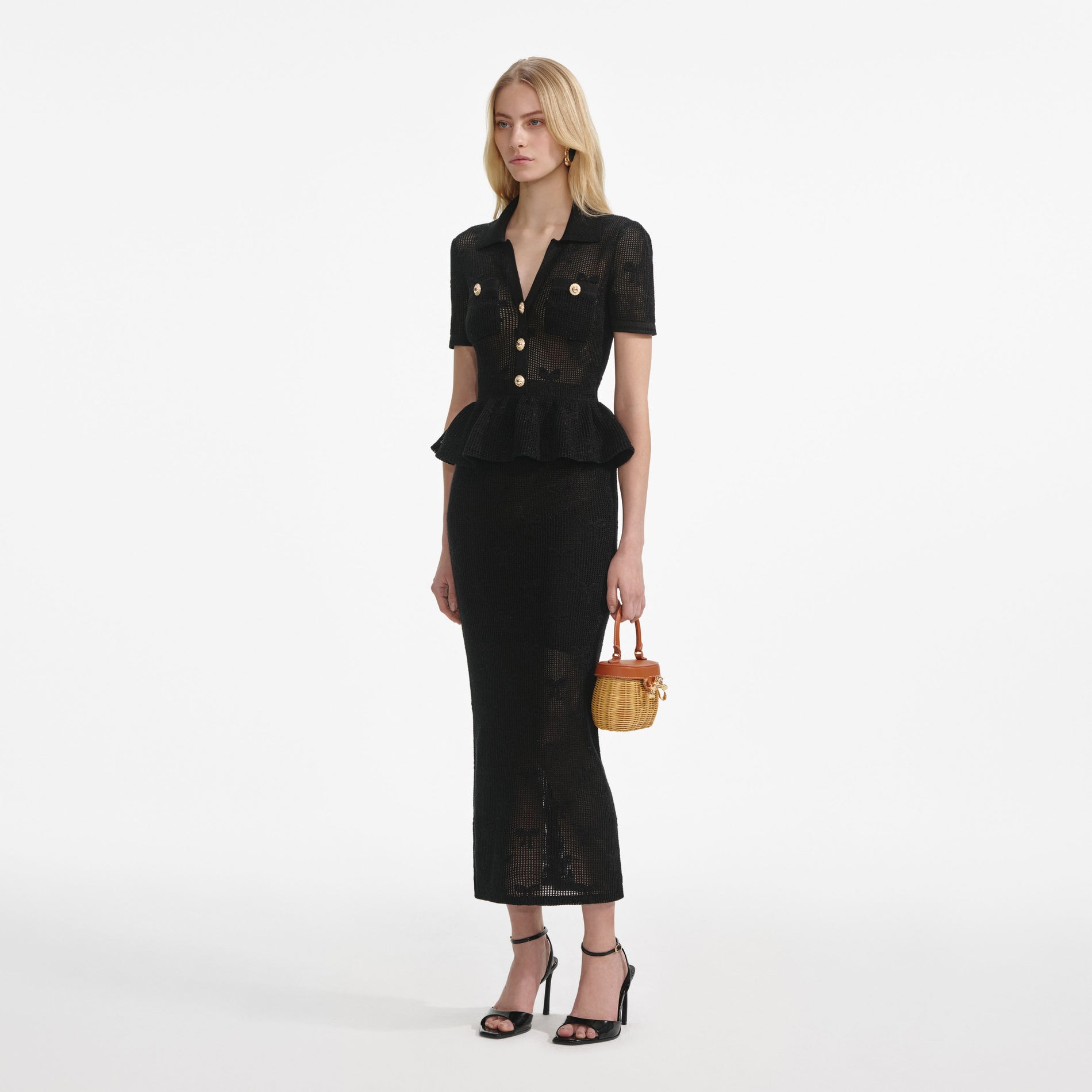 Side view of a woman wearing the Black Bow Crochet Midi Dress