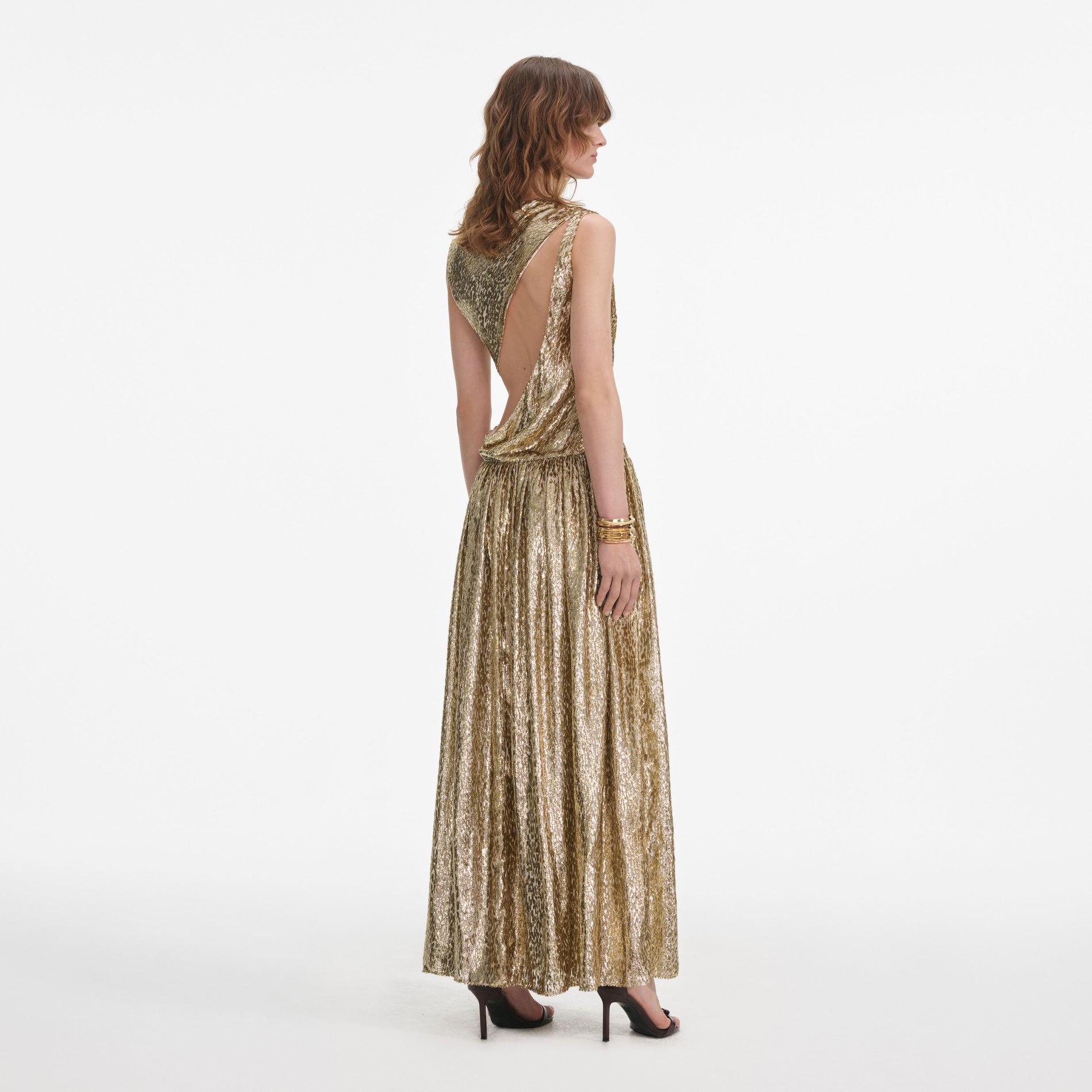 Back view of a woman wearing the Gold Sleeveless Fil Coupe Maxi Dress