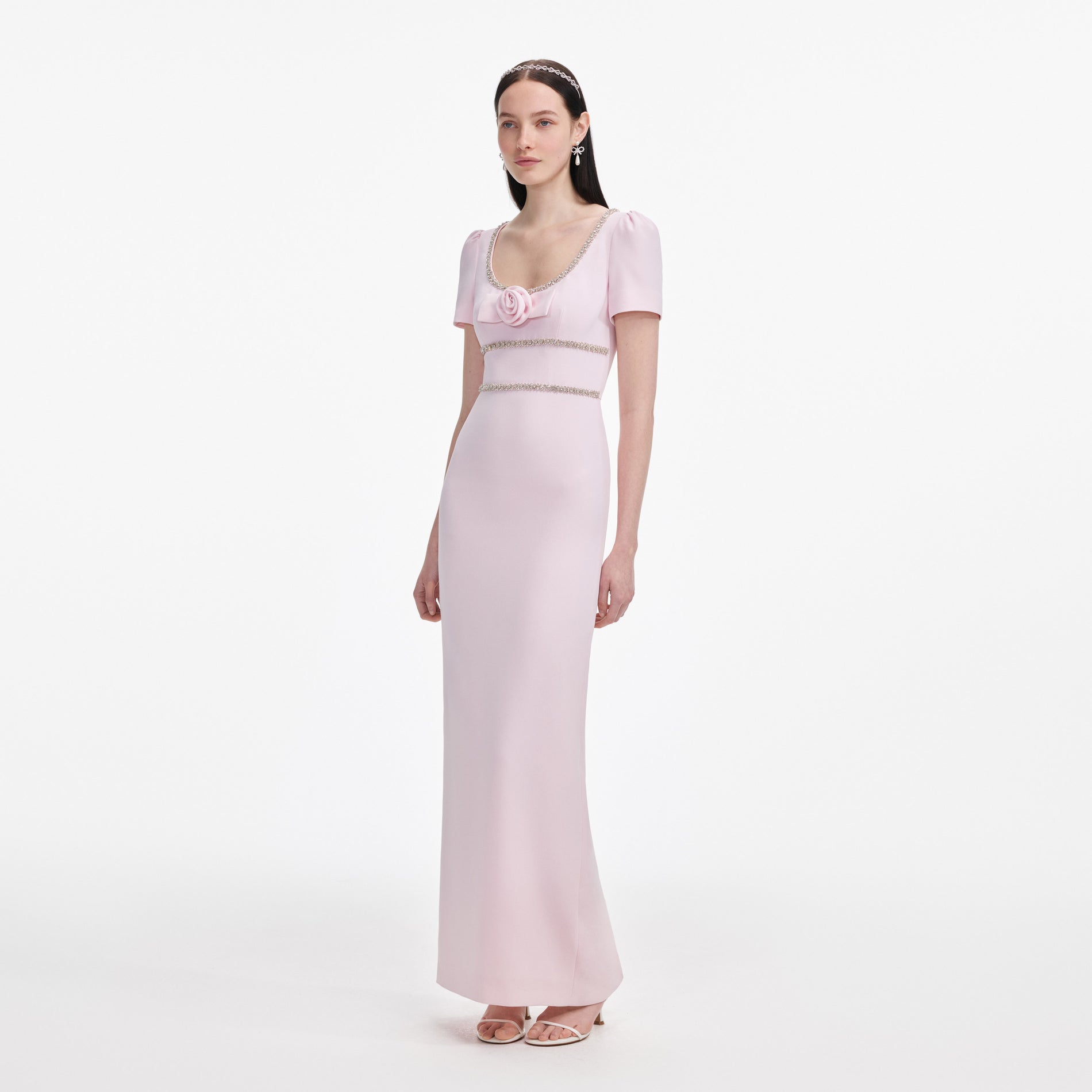 Side view of a woman wearing the Pink Crepe Crystal Trim Maxi Dress