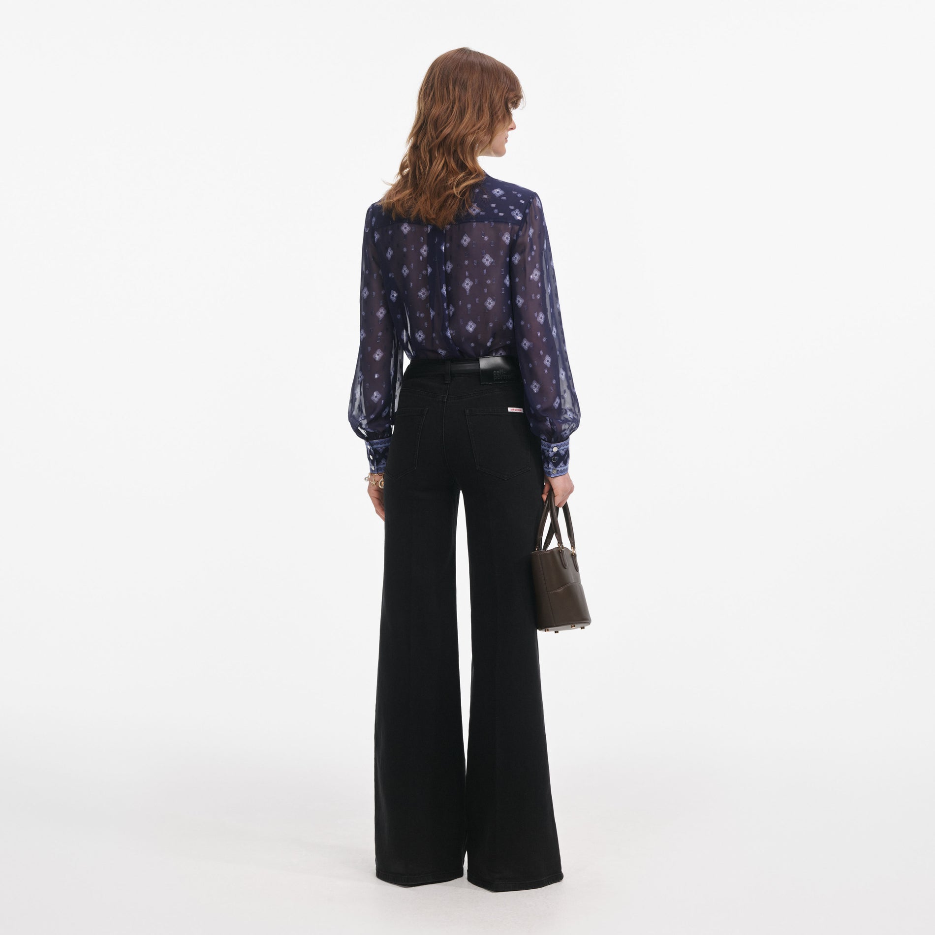 Back view of a woman wearing the Navy Printed Chiffon Blouse