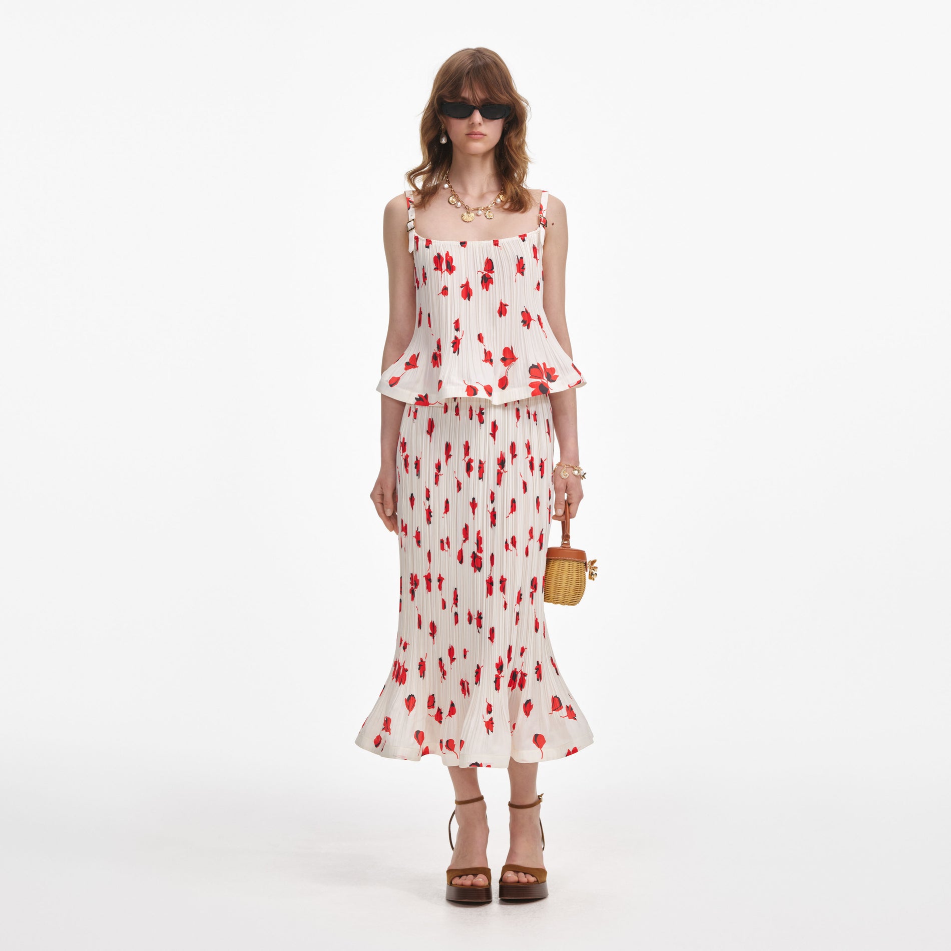 Front view of a woman wearing the White Floral Plisse Midi Skirt