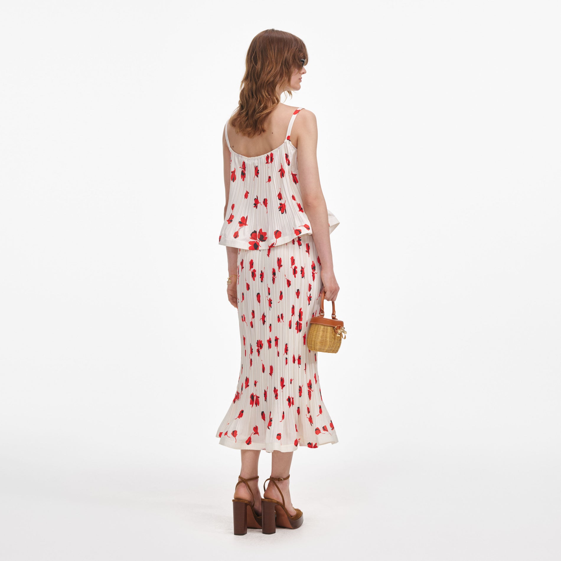 Back view of a woman wearing the White Floral Plisse Midi Skirt