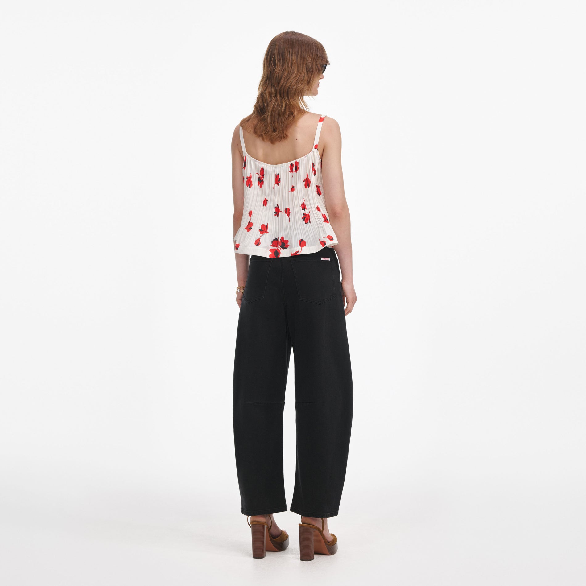 Back view of a woman wearing the White Floral Plisse Top