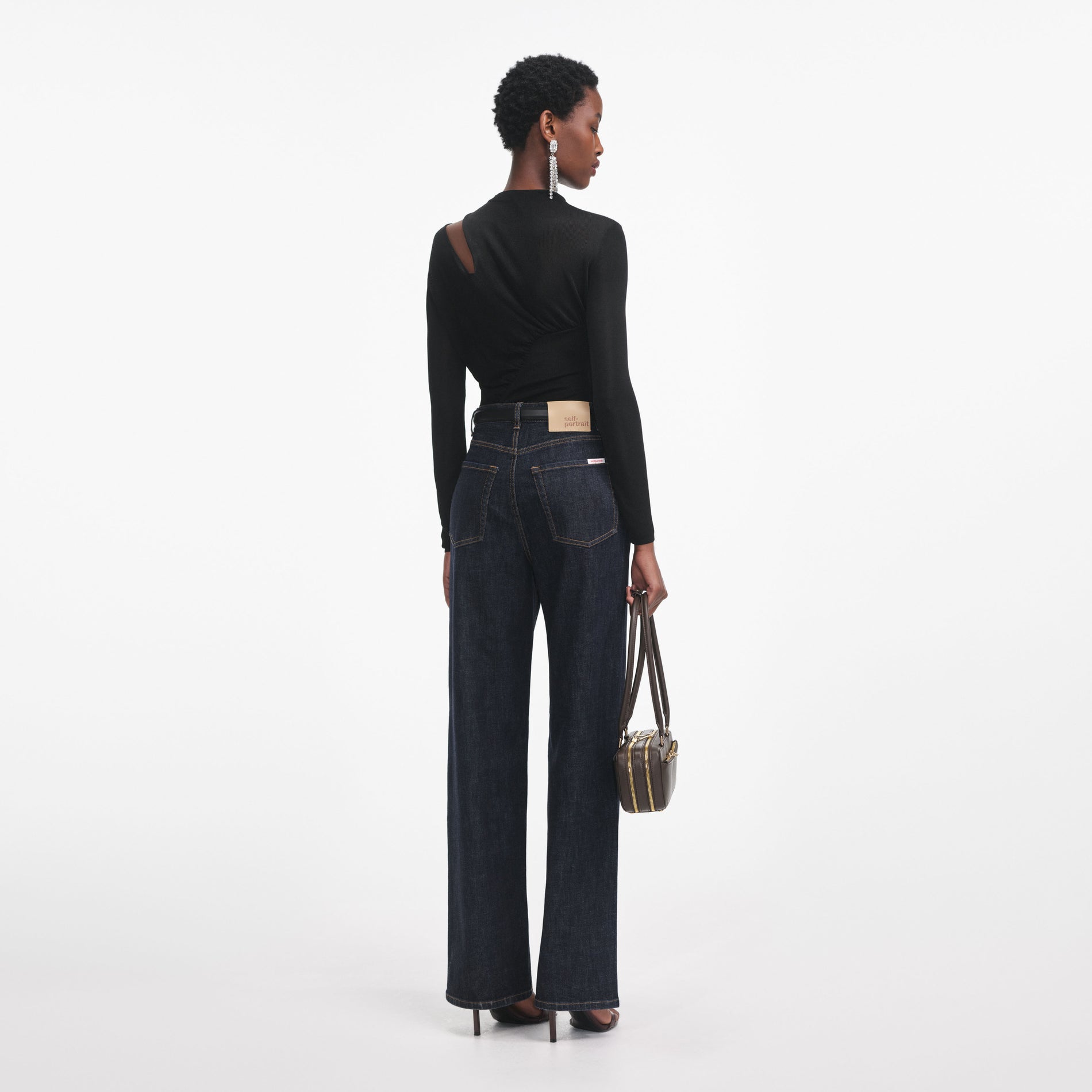 Back view of a woman wearing the Black Cut Out Viscose Knit Top