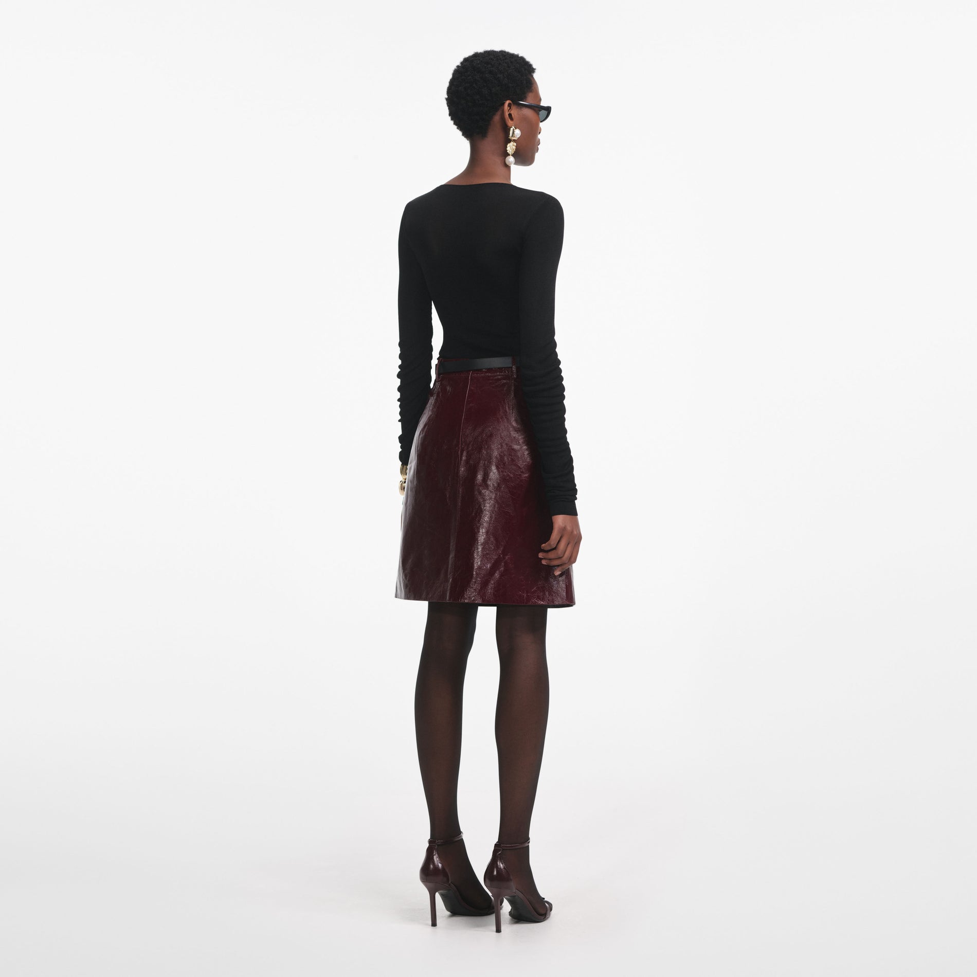 Back view of a woman wearing the Black Viscose Knit Top