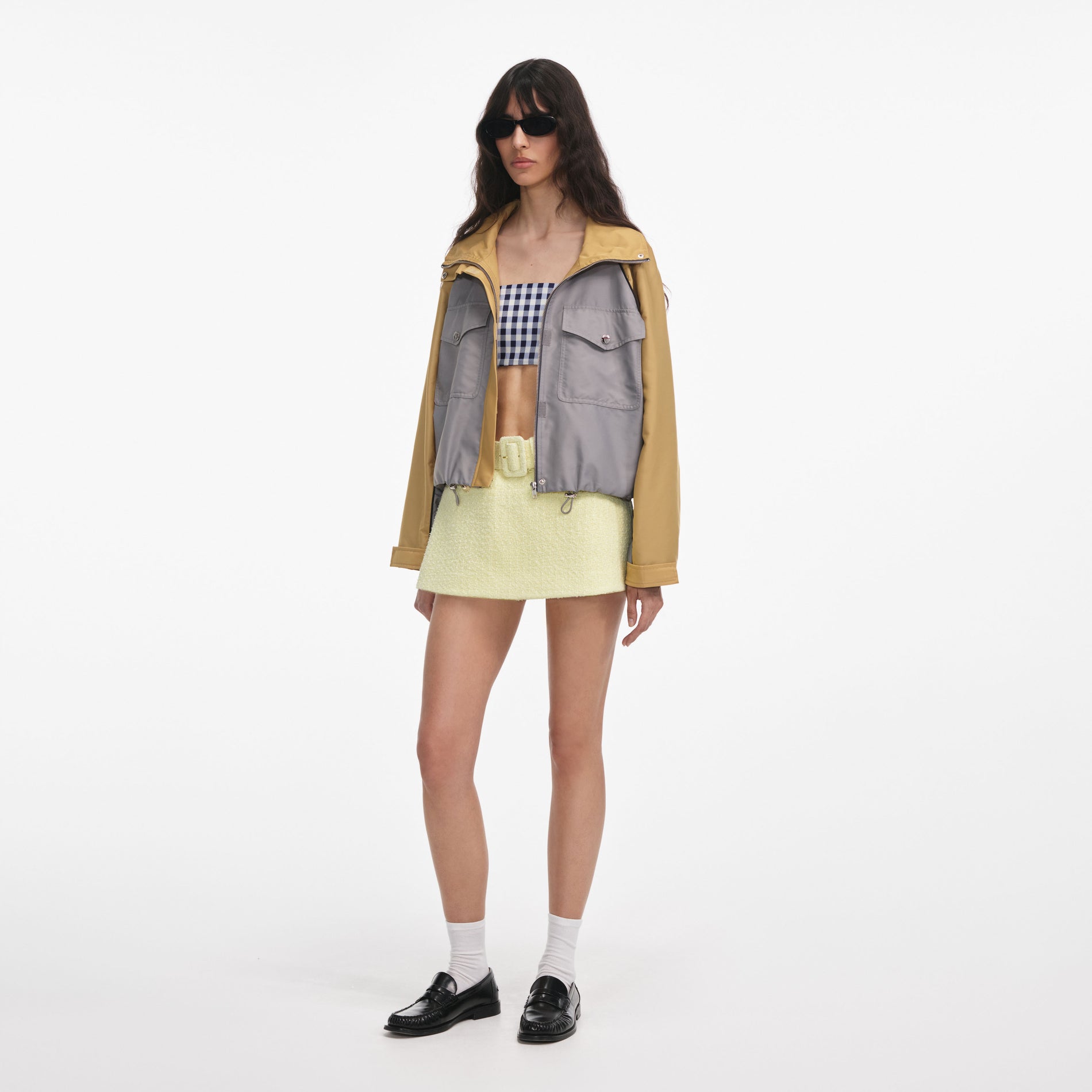 Side view of a woman wearing the Grey Nylon Cropped Windbreaker