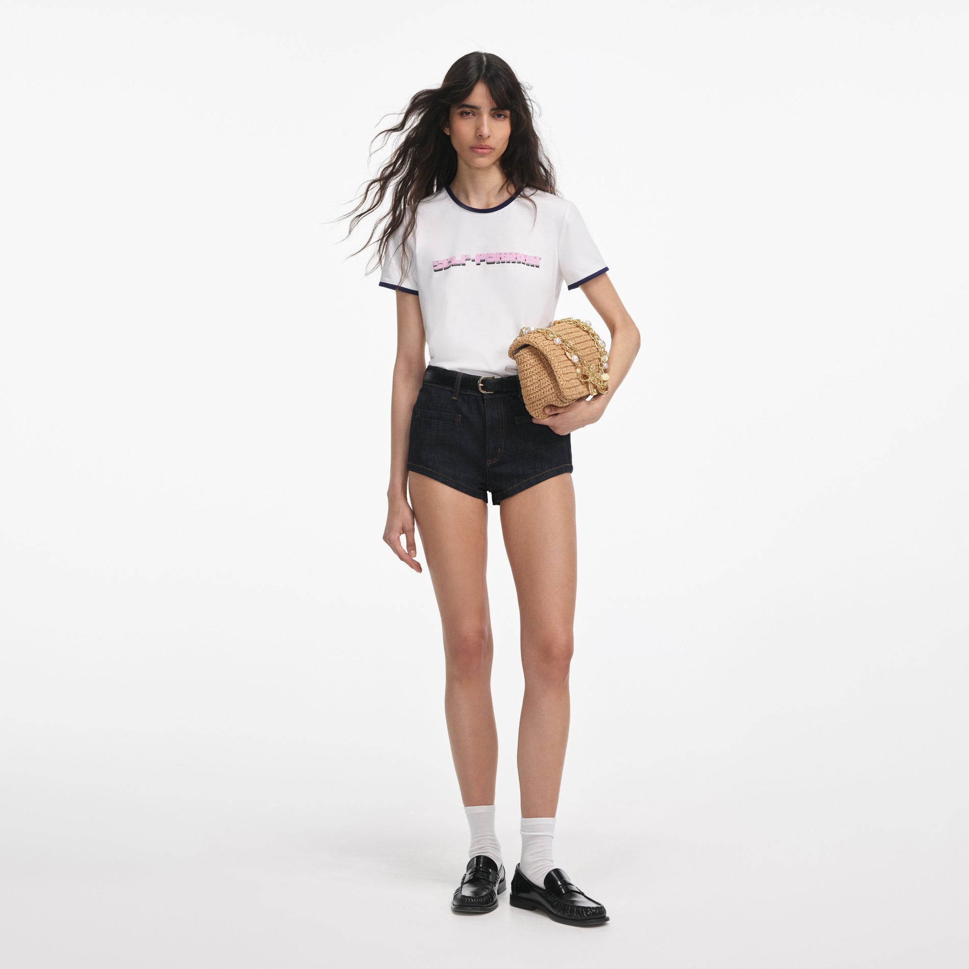 Front view of a woman wearing the White T-Shirt With Pink Logo