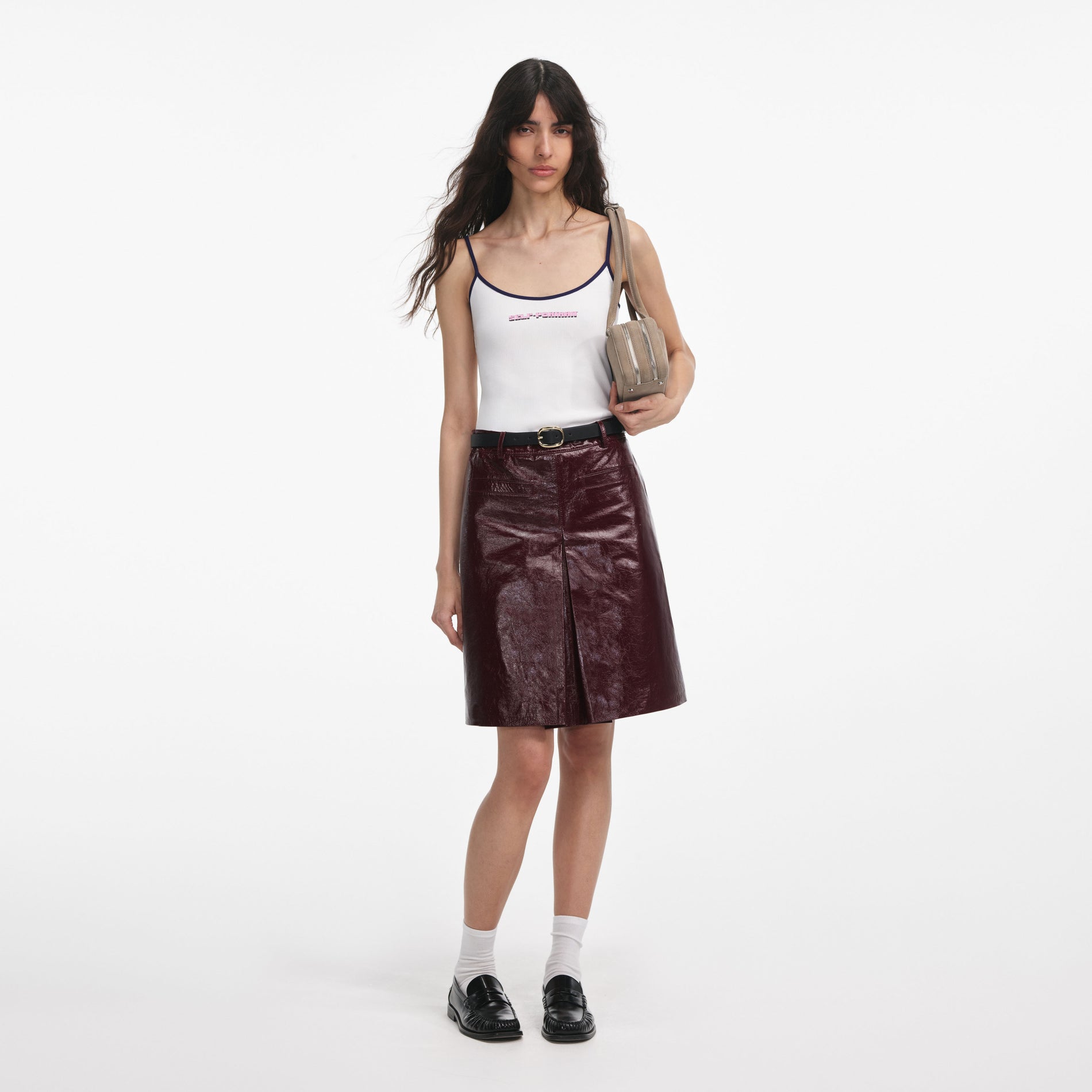 Front view of a woman wearing the White Vest With Pink Logo