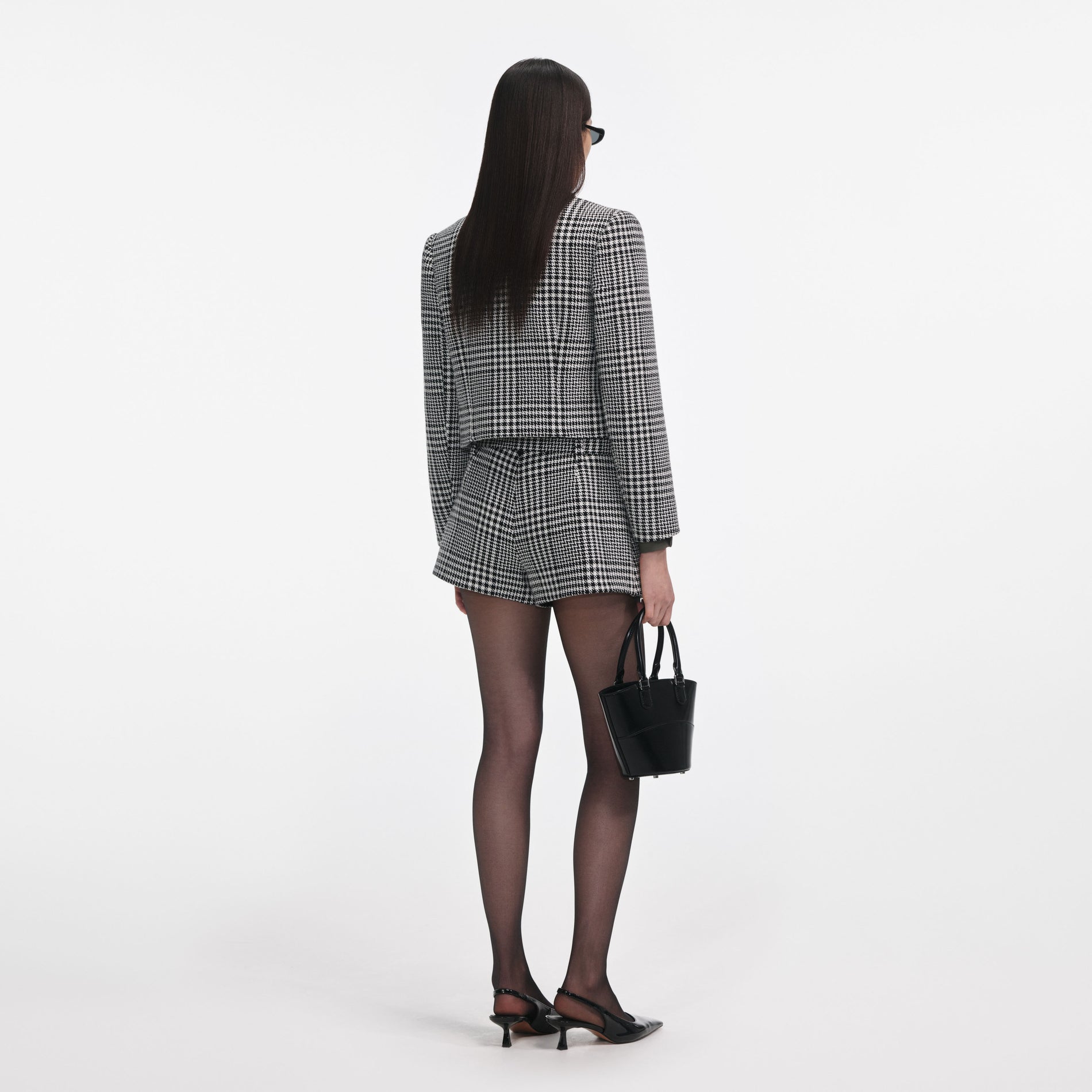 Back view of a woman wearing the Houndstooth Crystal Trim Jacket
