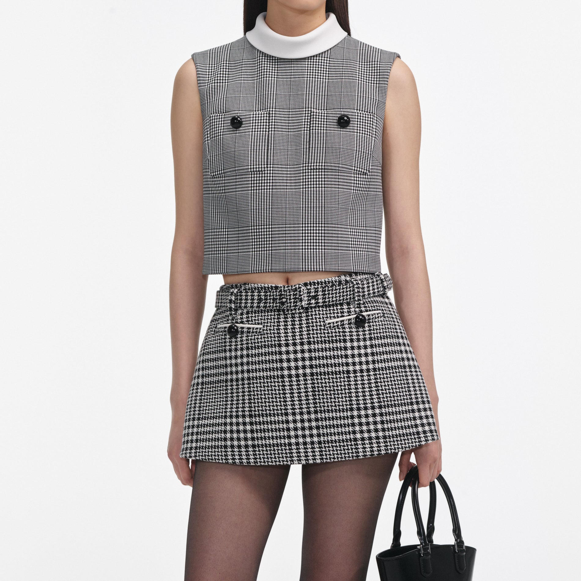 A close up of a woman wearing the Houndstooth Skort
