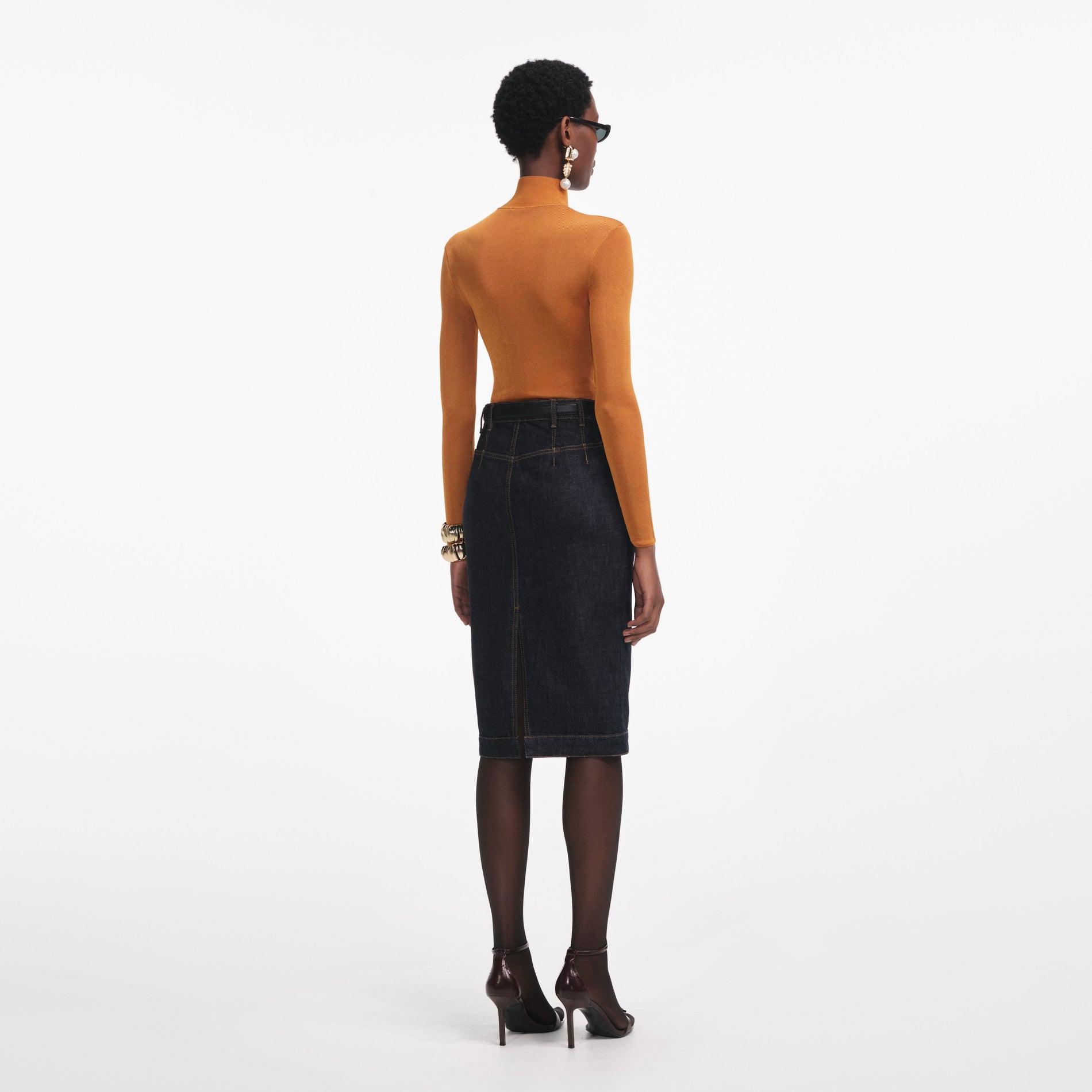 Back view of a woman wearing the Burnt Orange Viscose Knit Top