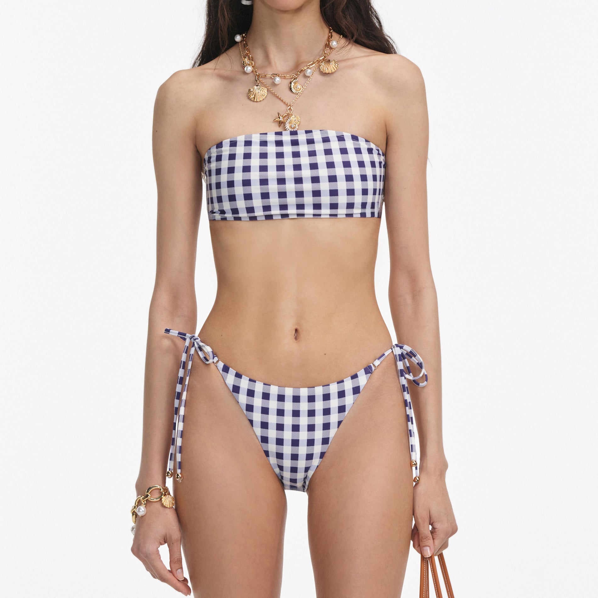 A close up of a woman wearing the Navy Gingham Bikini Top