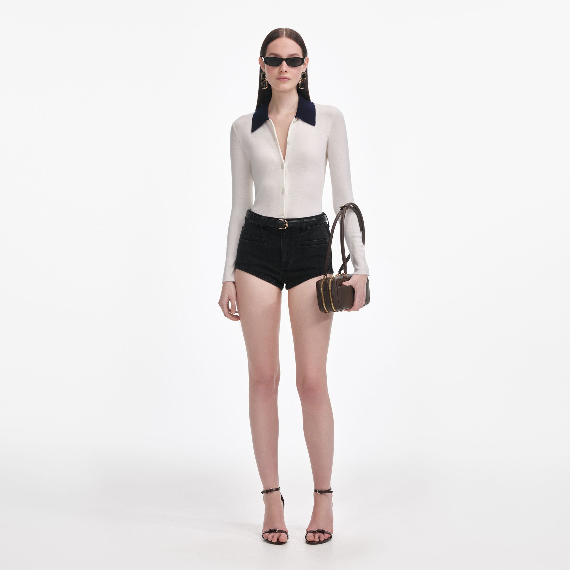 Front view of a woman wearing the Black Denim Shorts