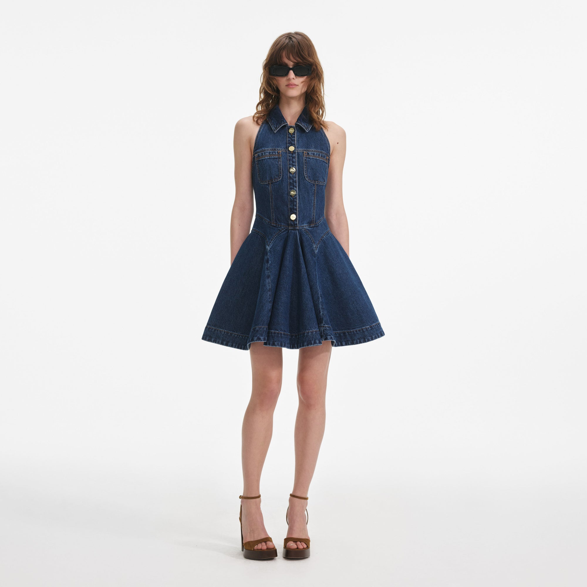 Front view of a woman wearing the Denim Sleeveless Flared Mini Dress