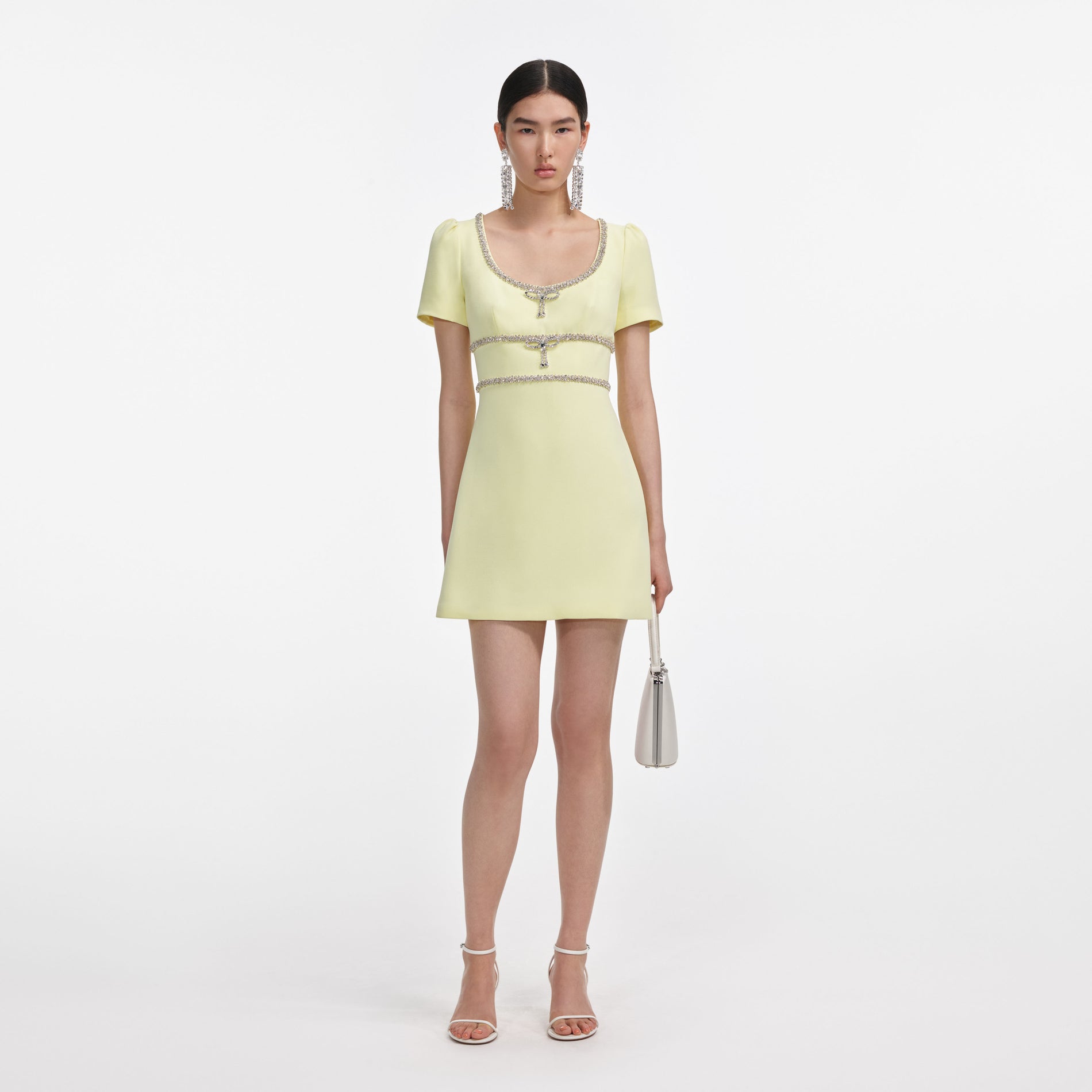 Front view of a woman wearing the Yellow Crepe Crystal Trim Mini Dress
