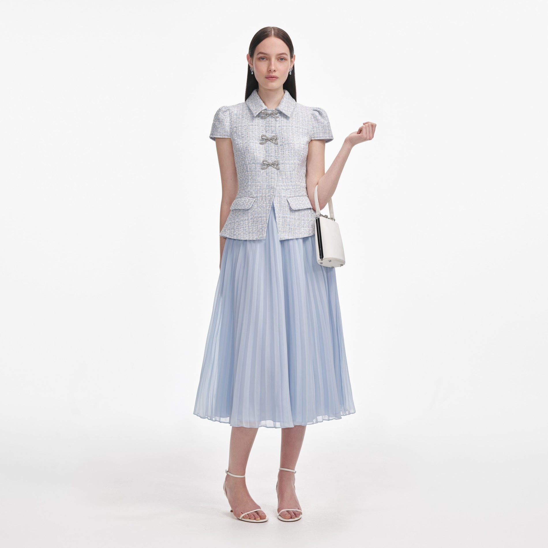 Front view of a woman wearing the Blue Boucle Bow Midi Dress