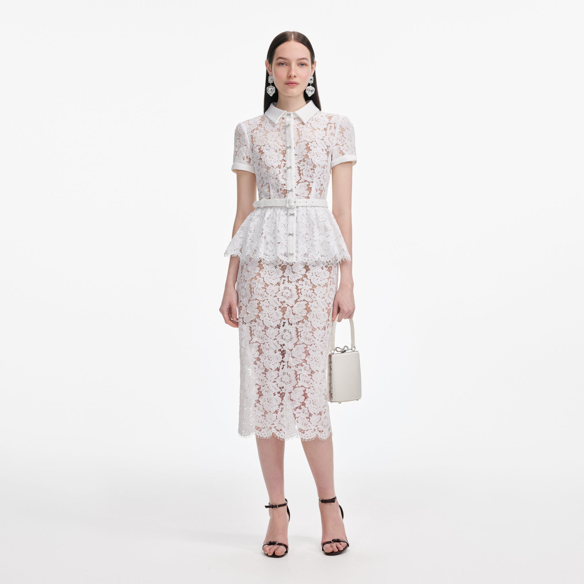 Front view of a woman wearing the White Lace Peplum Midi Dress