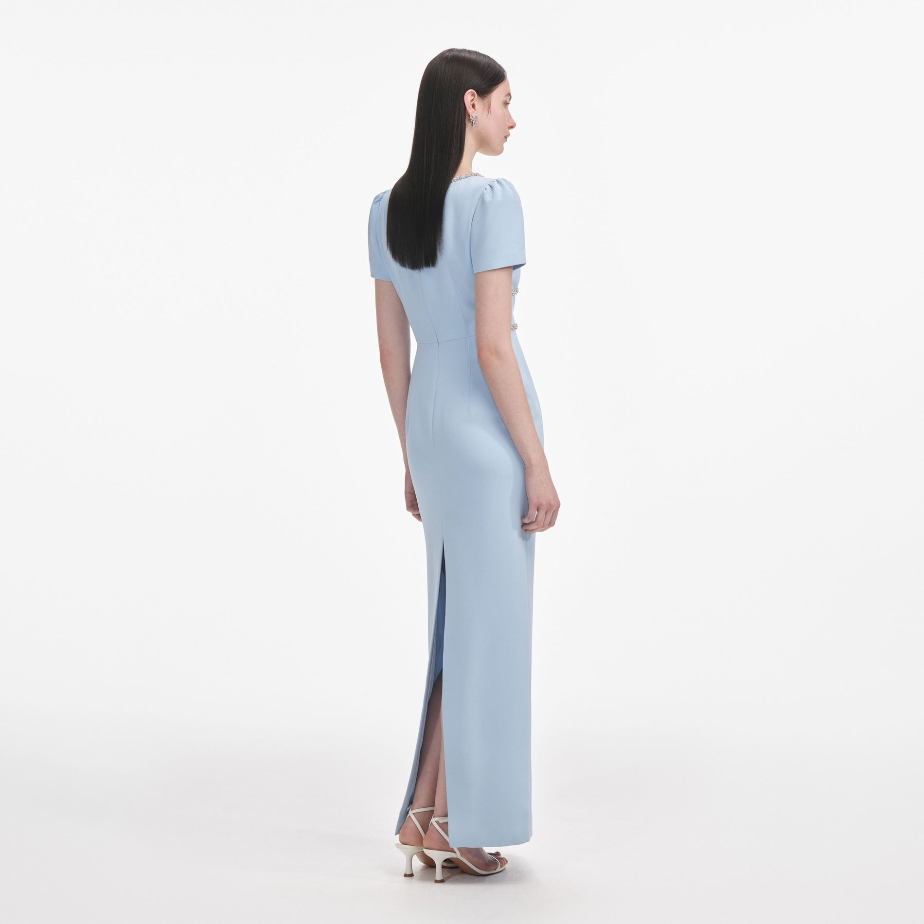 Back view of a woman wearing the Blue Crepe Crystal Trim Maxi Dress