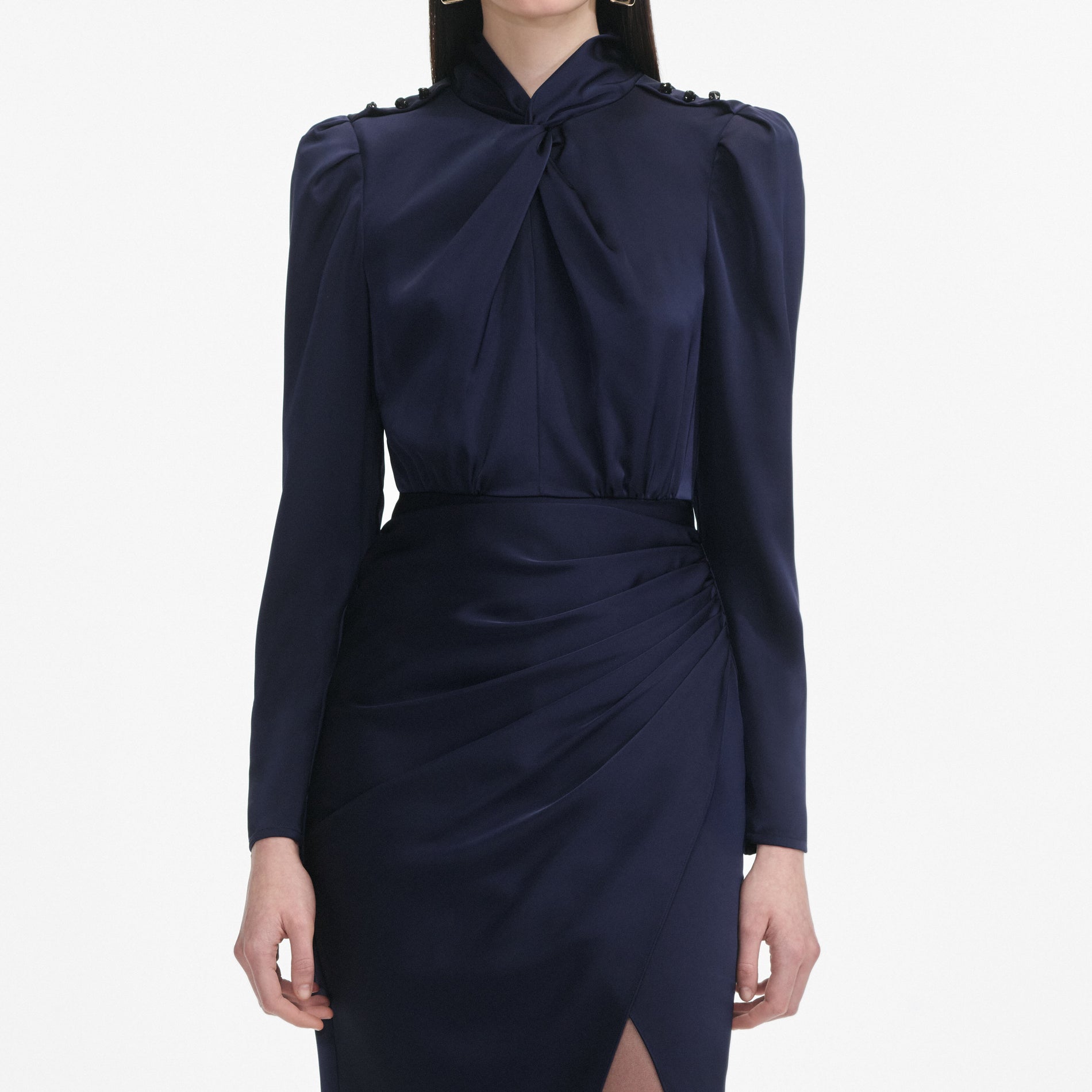 A close up of a woman wearing the Navy Satin Midi Dress