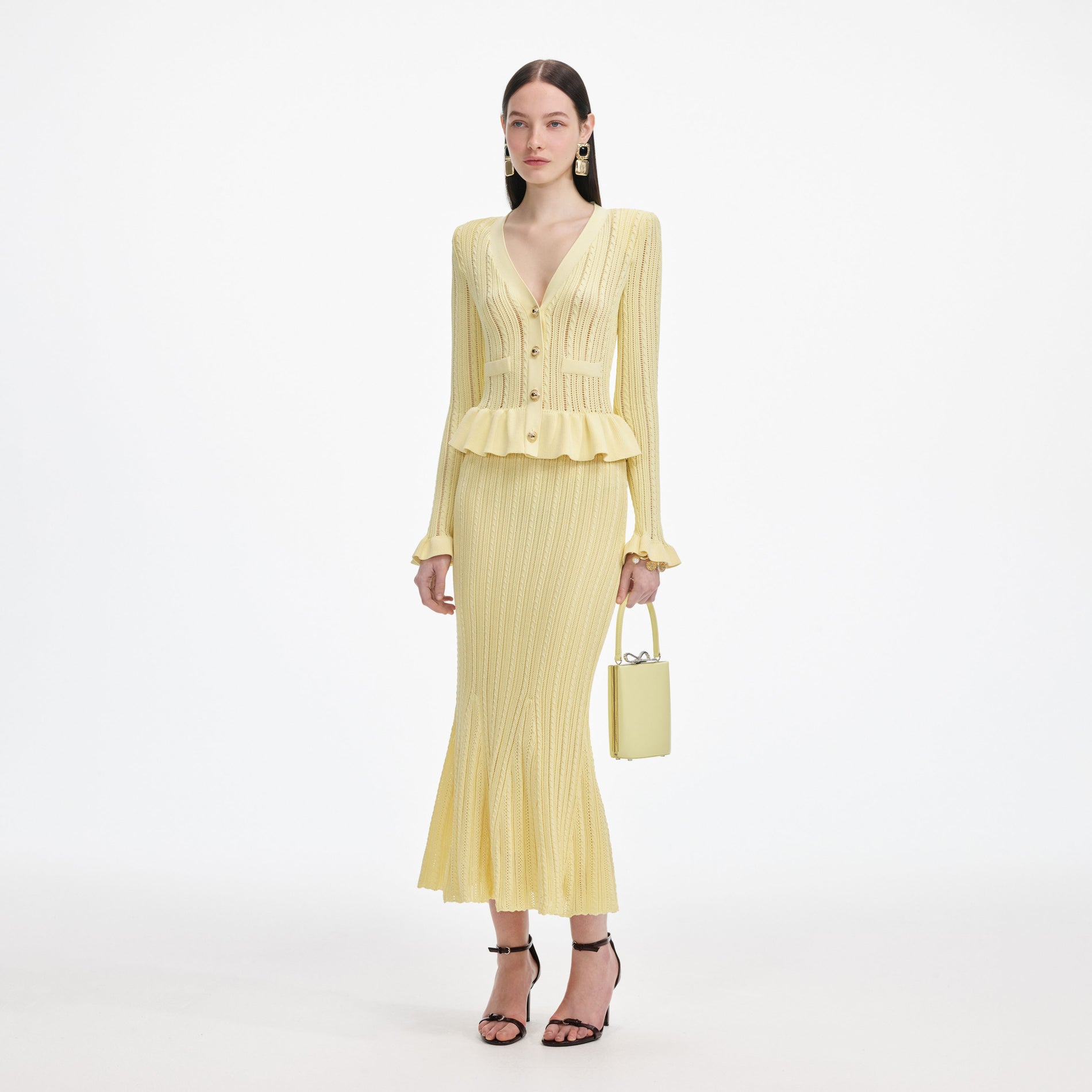 Side view of a woman wearing the Yellow Knit Peplum Midi Dress