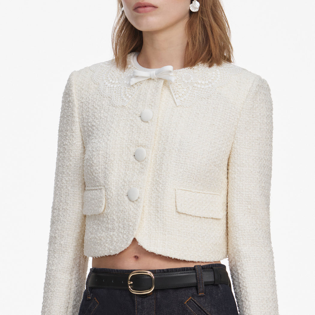 A close up of a woman wearing the Cream Boucle Lace Collar Jacket