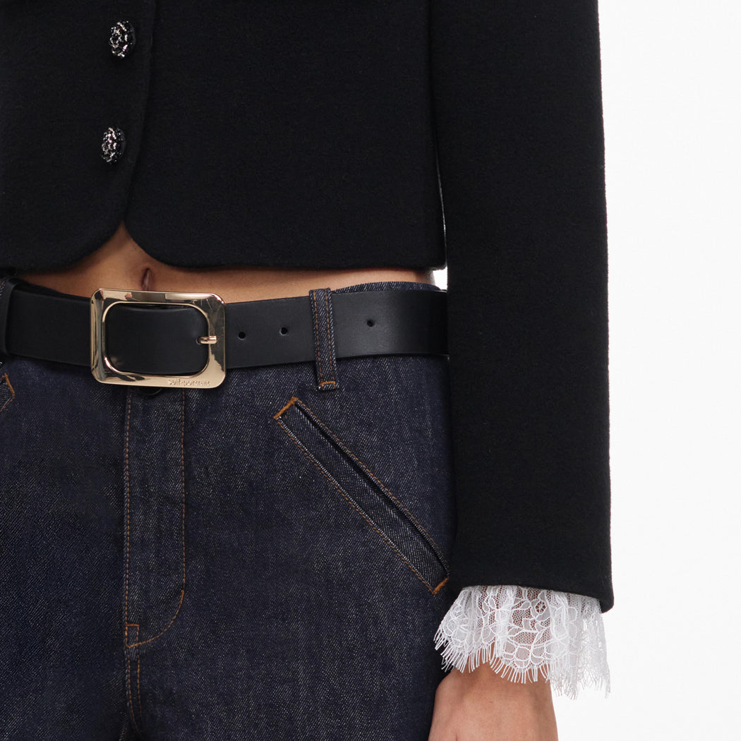 A close up of a woman wearing the Black Button Down Jacket