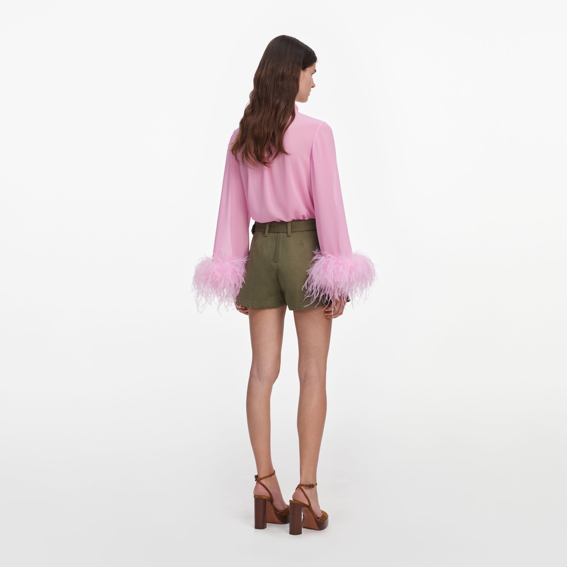 Back view of a woman wearing the Pink Georgette Feather Cuff Blouse