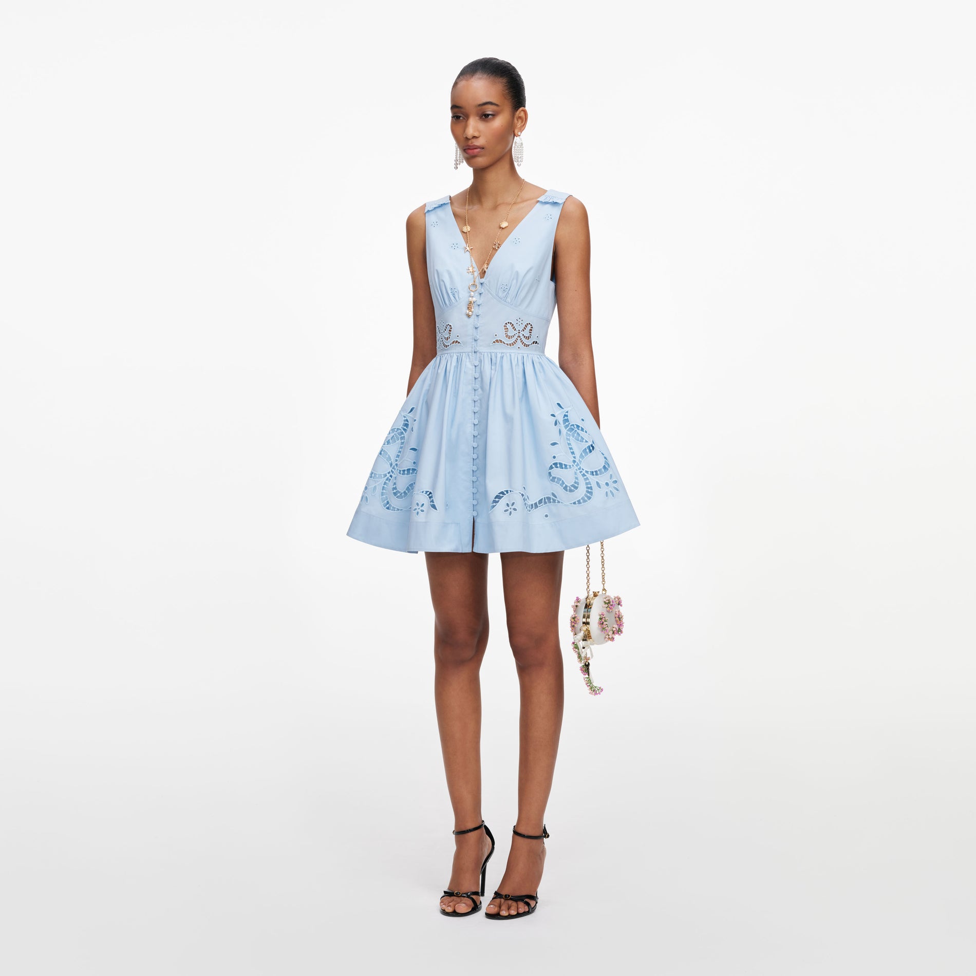 Side view of a woman wearing the Blue Cotton Embroidered Mini Dress