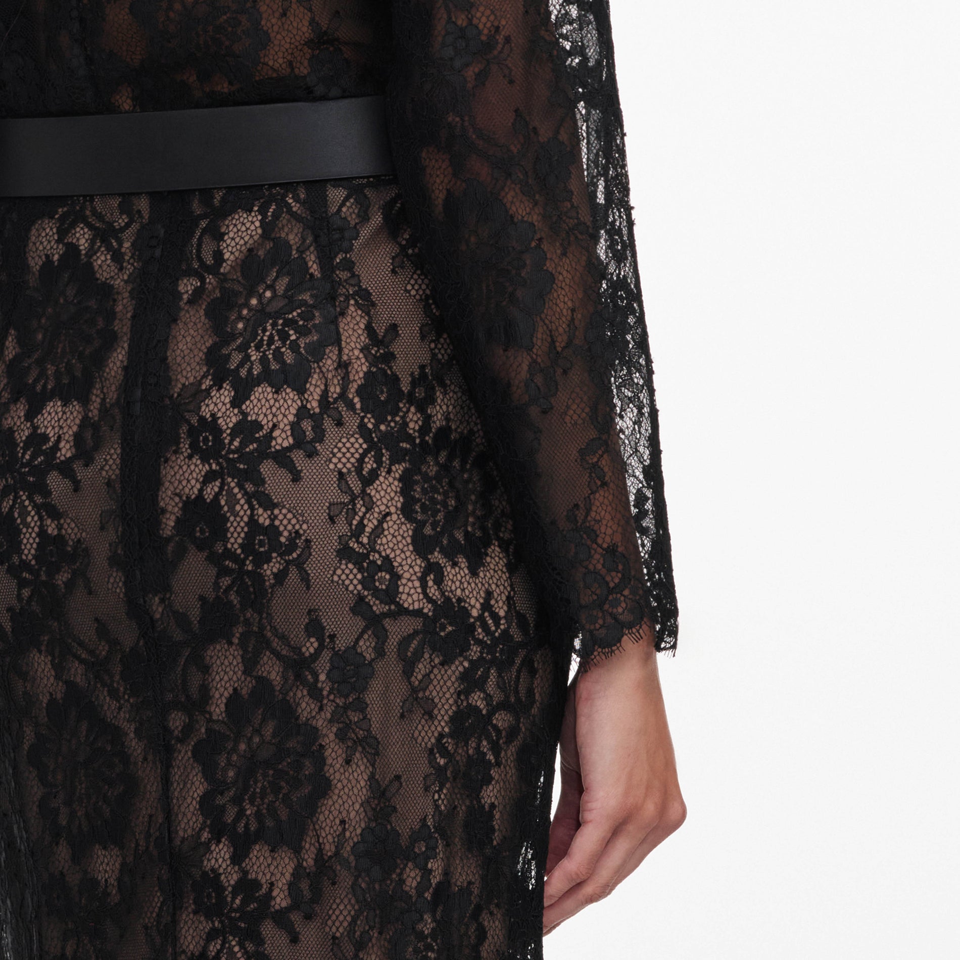 A close up of a woman wearing the Black Lace Midi Skirt