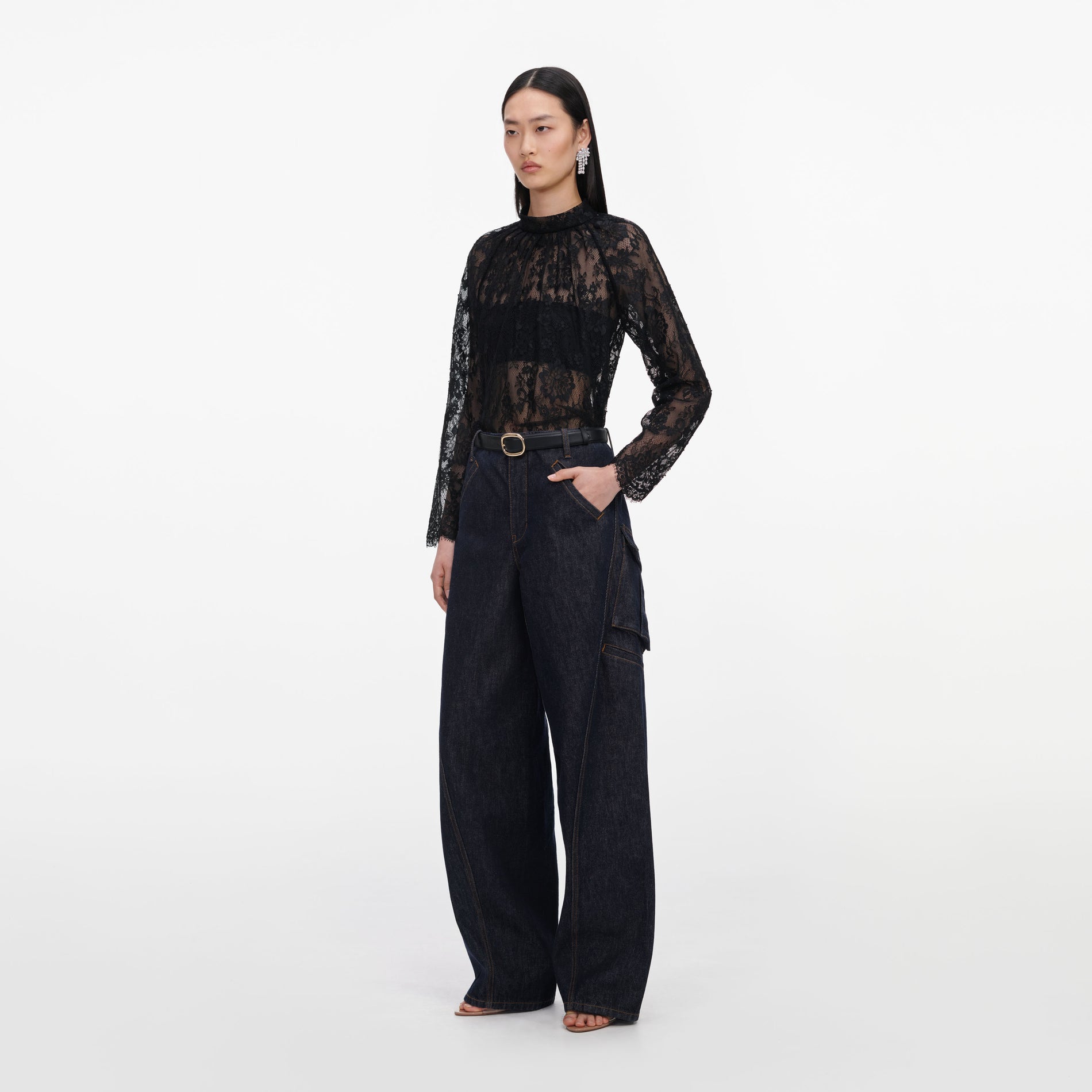 Side view of a woman wearing the Black Lace Blouse