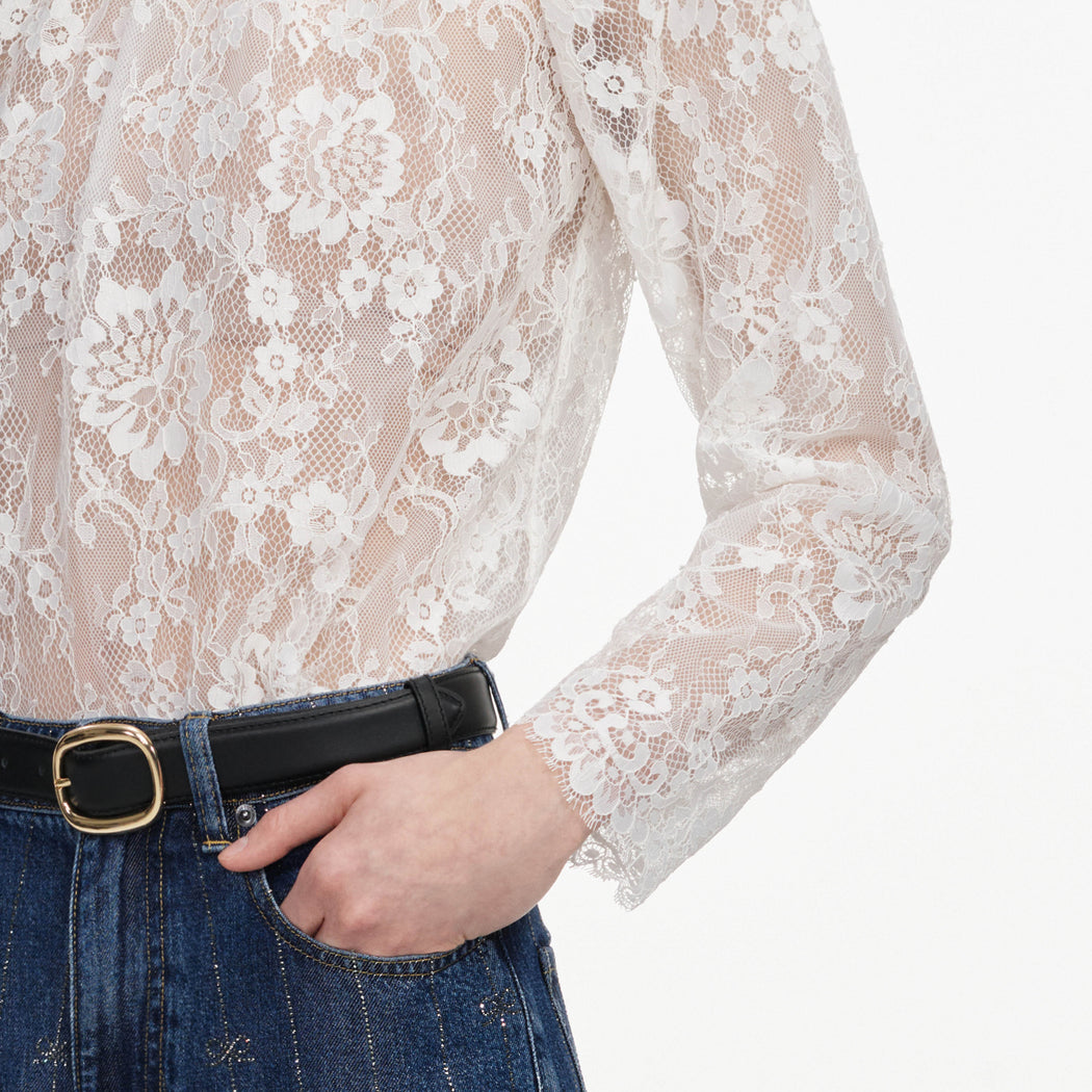 A close up of a woman wearing the White Lace Blouse