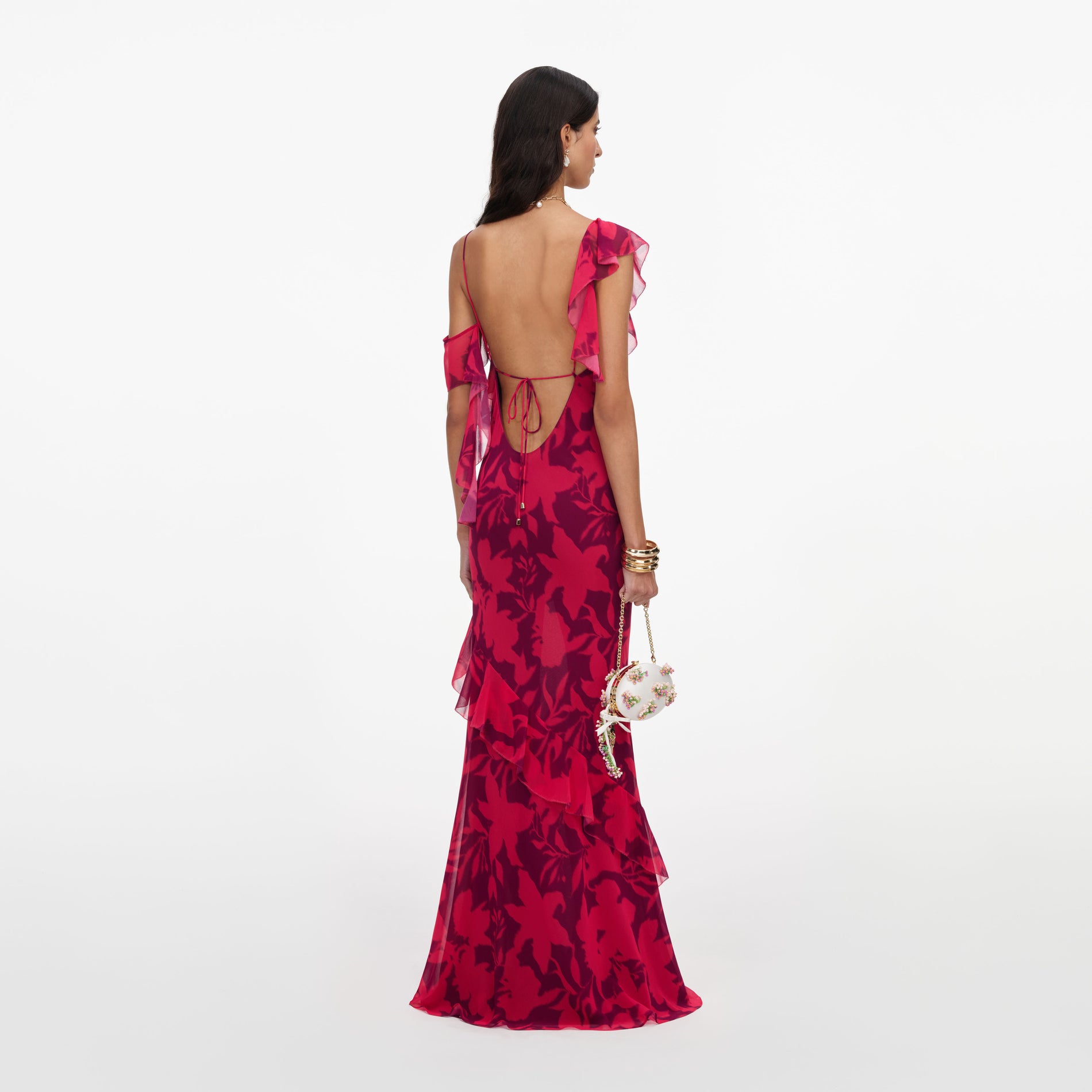 Back view of a woman wearing the Pink Floral Ruffle Maxi Dress