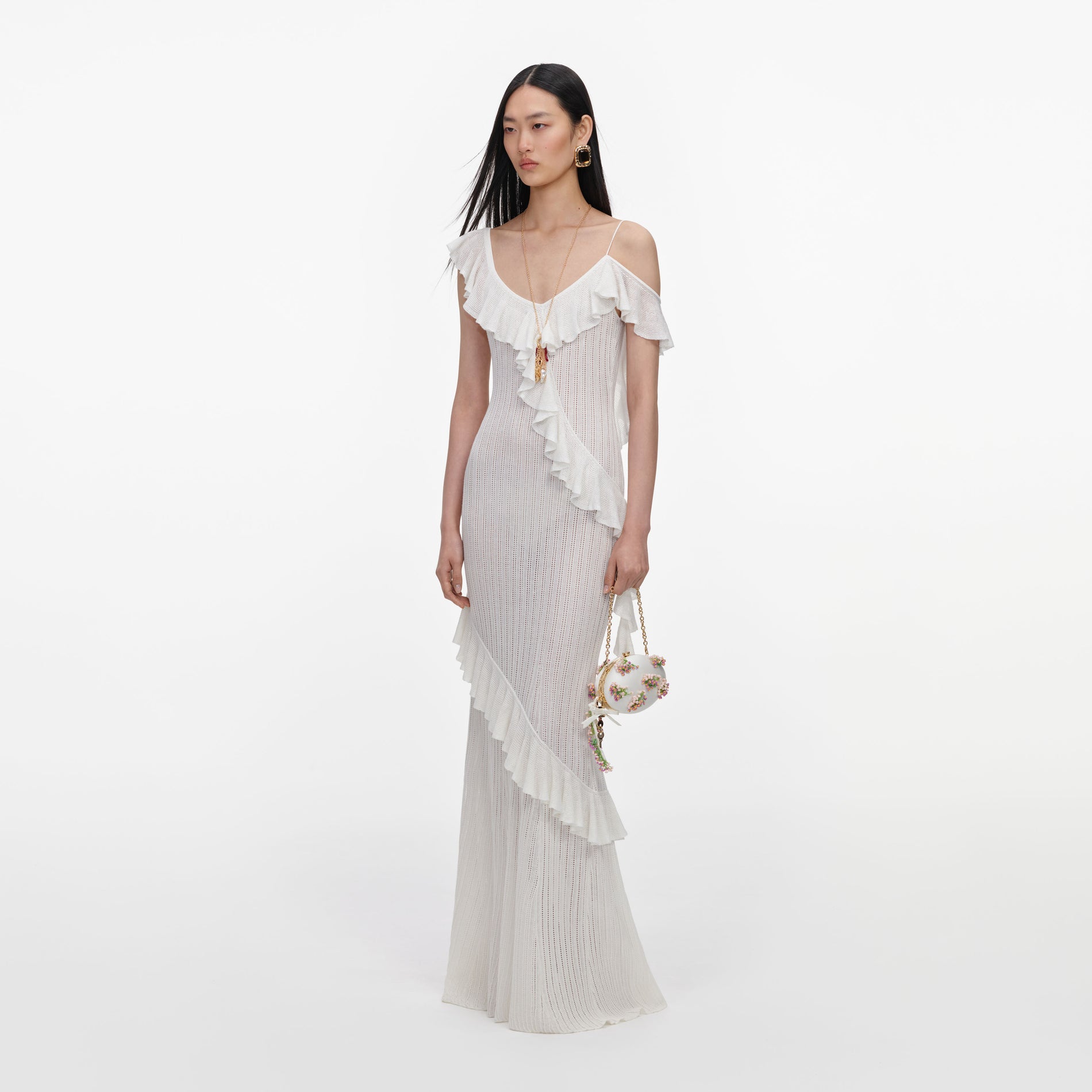 Side view of a woman wearing the White Ruffle Knit Maxi Dress