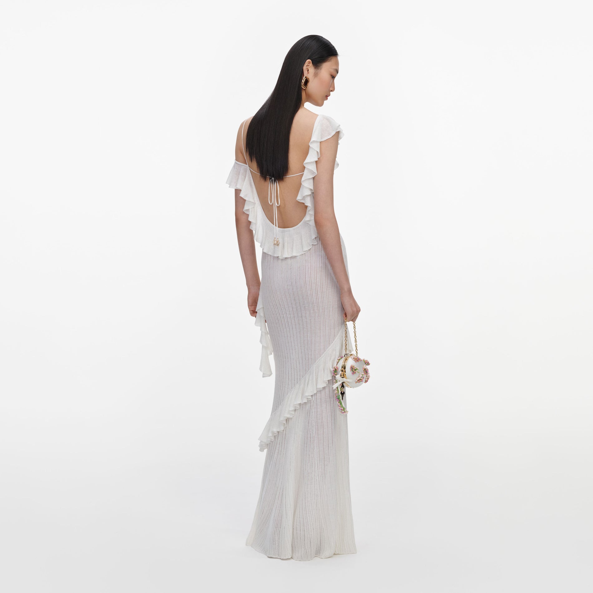 Back view of a woman wearing the White Ruffle Knit Maxi Dress