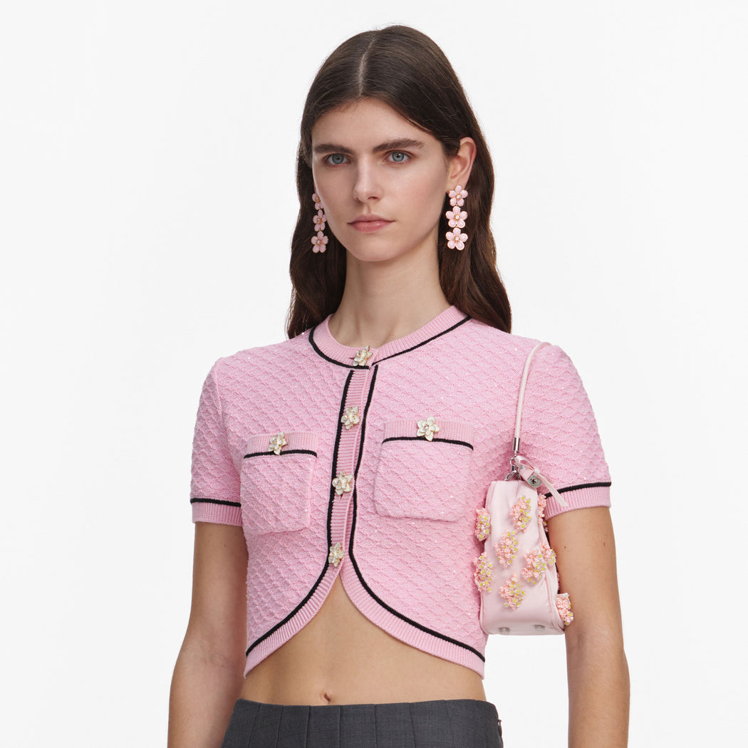 A close up of a woman wearing the Pink Flower Knit Top