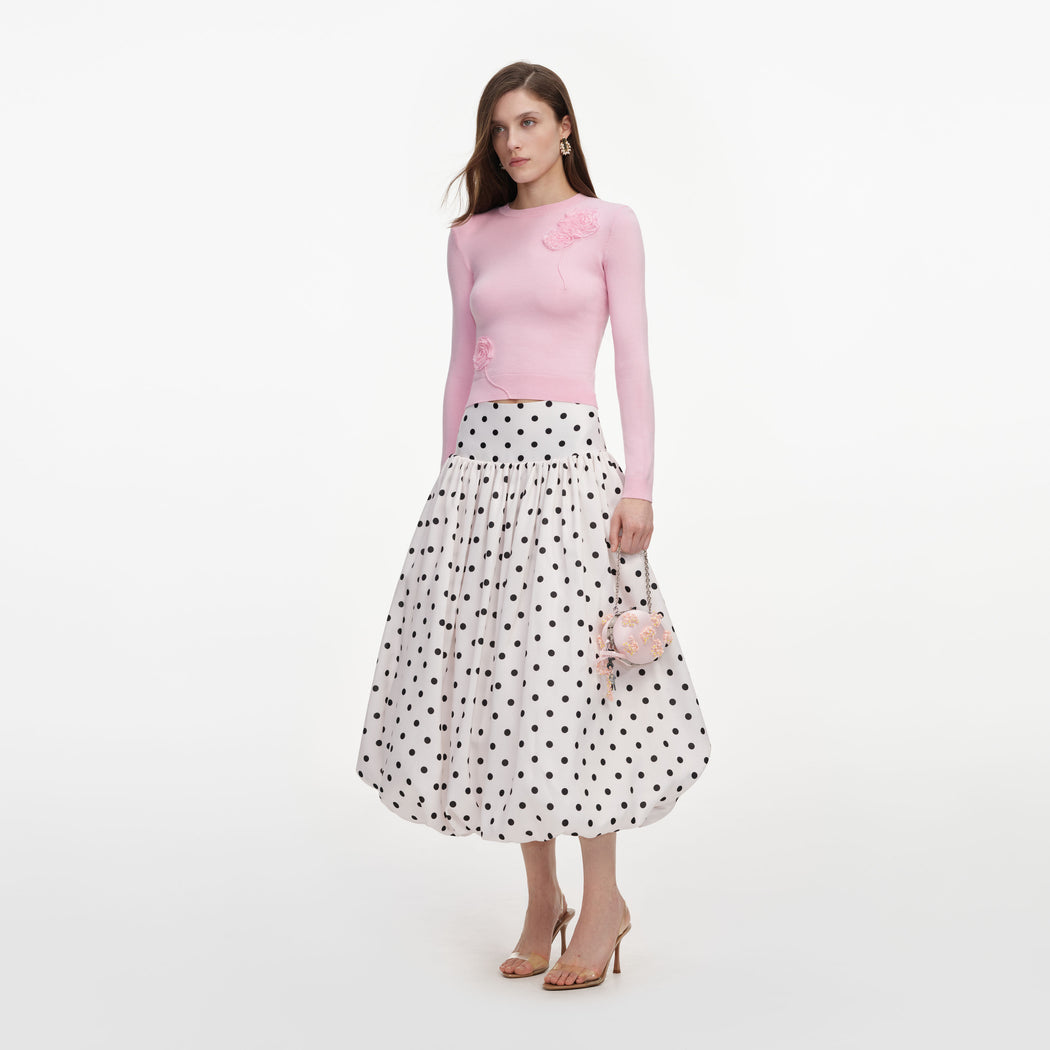 Side view of a woman wearing the Cream Polka Dot Taffeta Midi Skirt