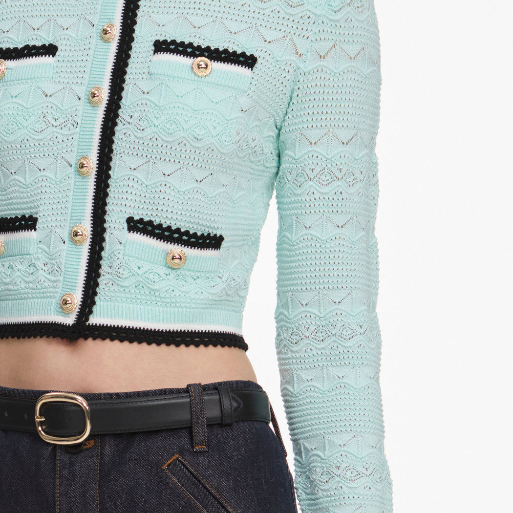 A close up of a woman wearing the Mint Pointelle Knit Cardigan