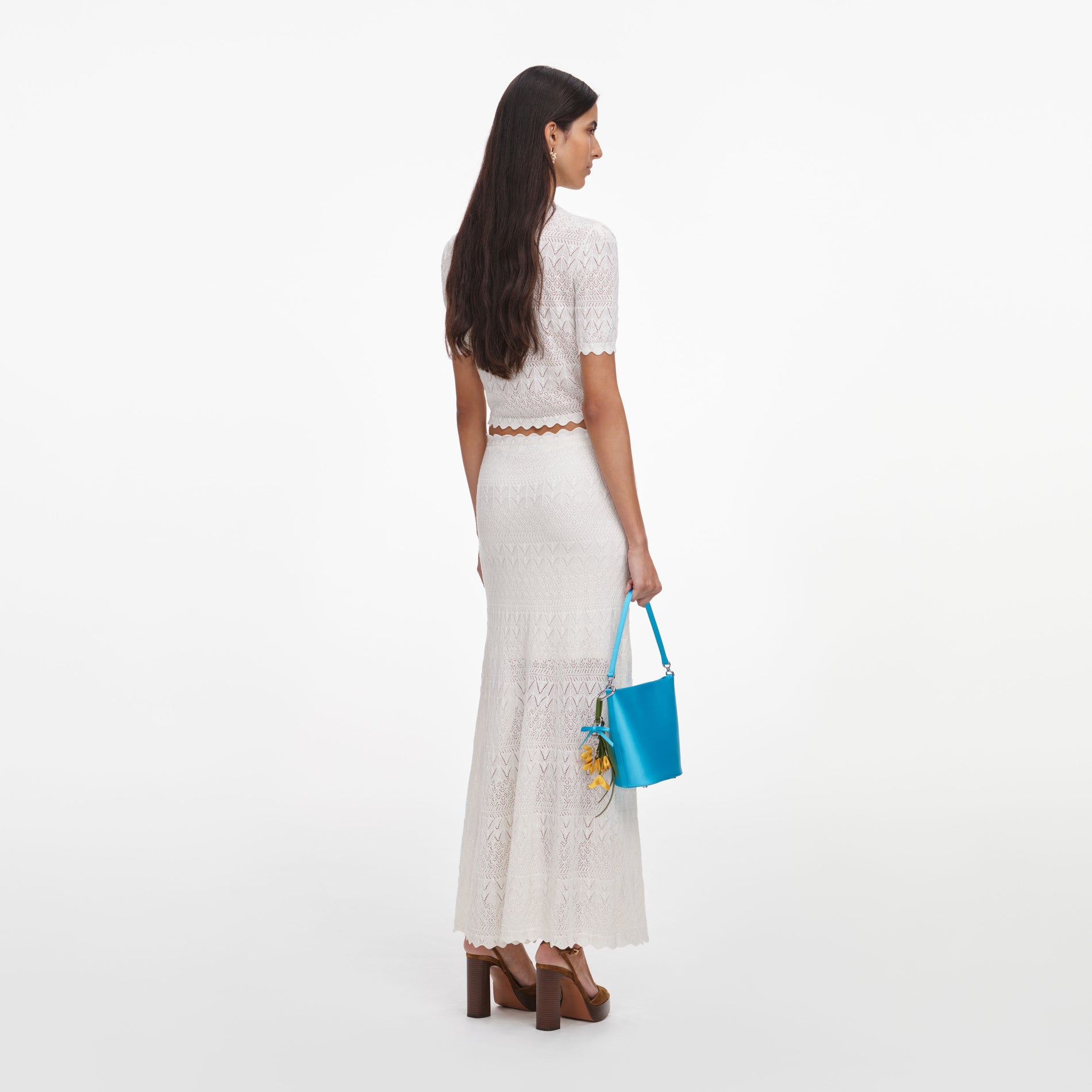 Back view of a woman wearing the White Pointelle Knit Midi Skirt
