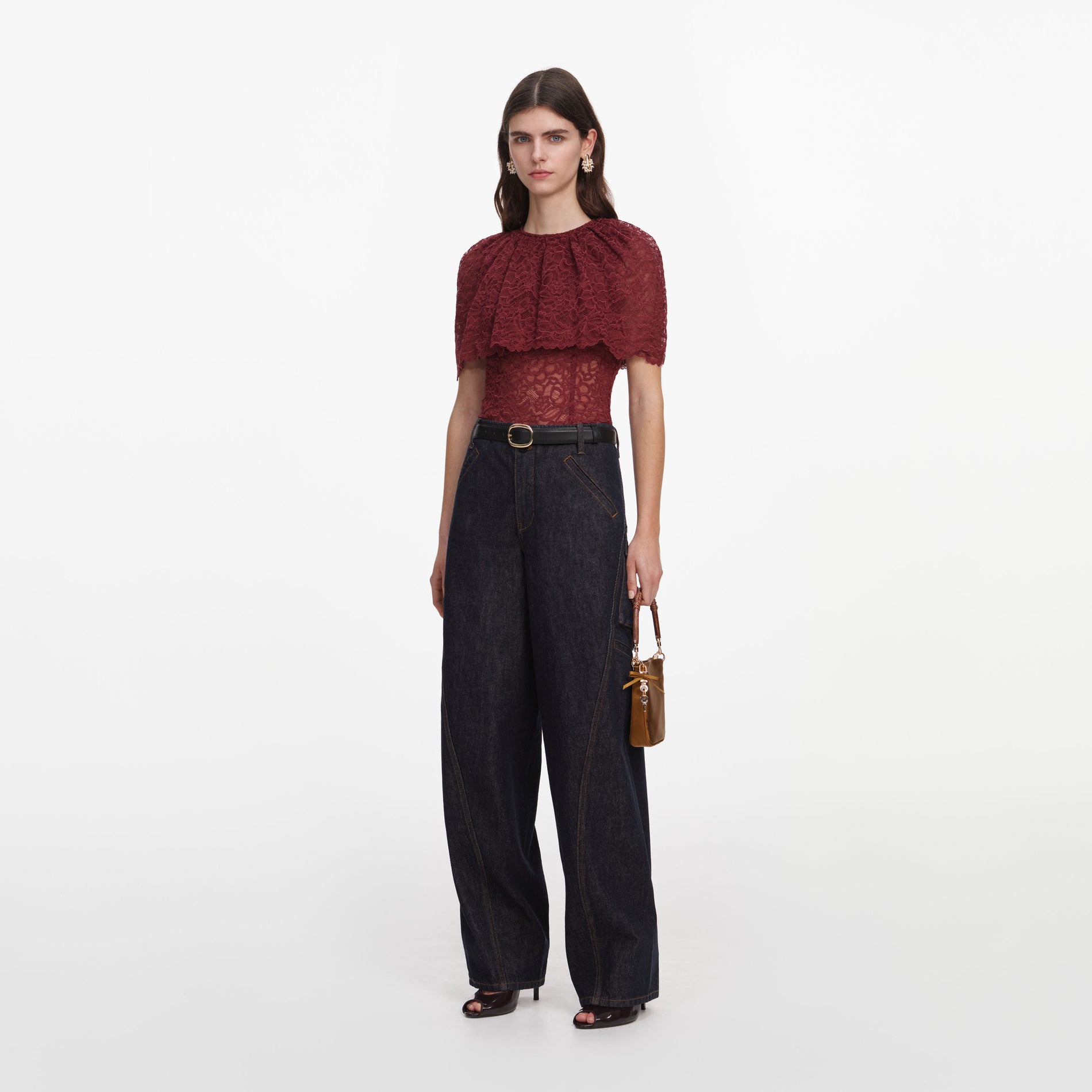 Side view of a woman wearing the Burgundy Lace Cape Top