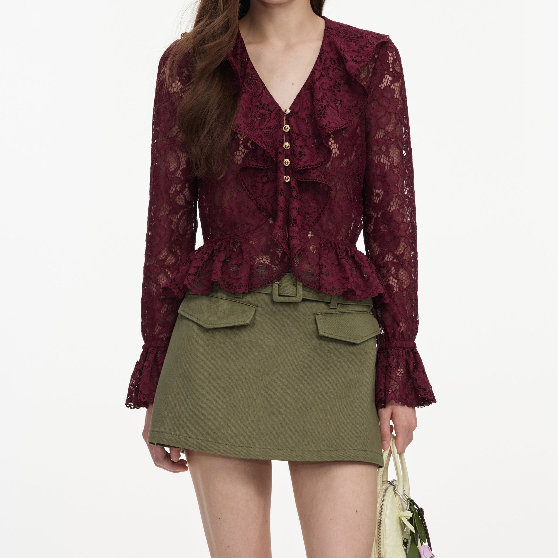 A close up of a woman wearing the Plum Lace Ruffle Top