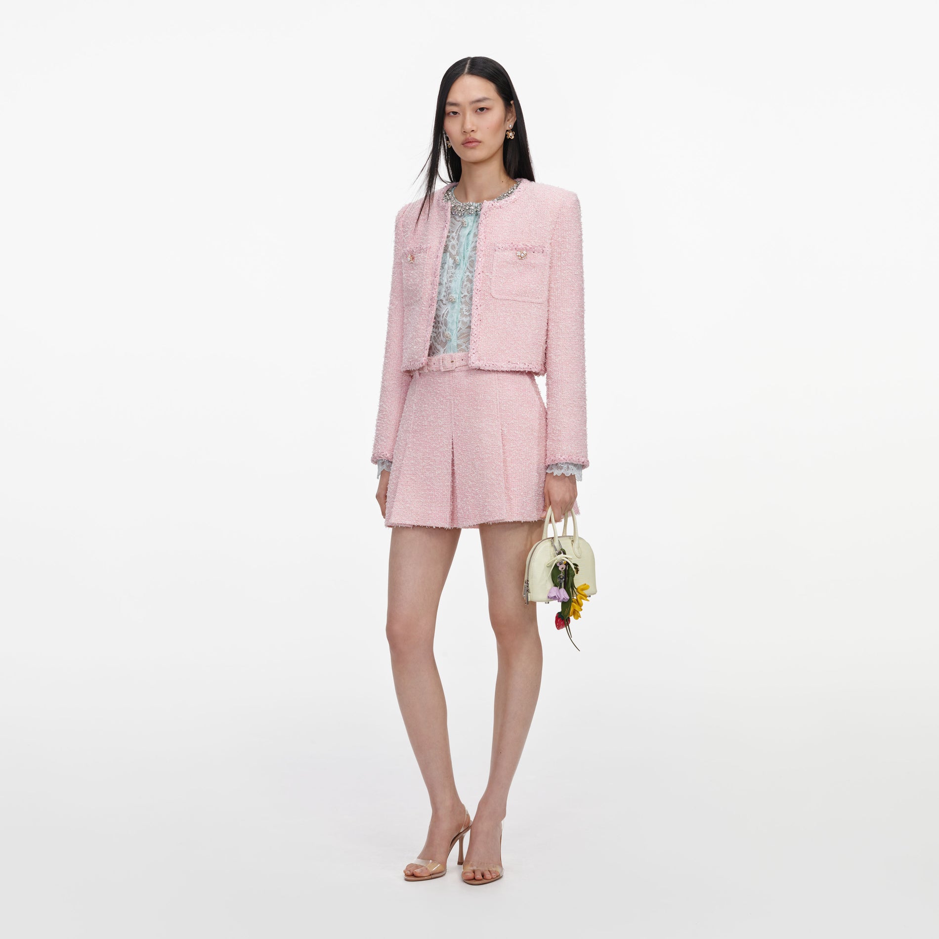 Side view of a woman wearing the Pink Boucle Jacket