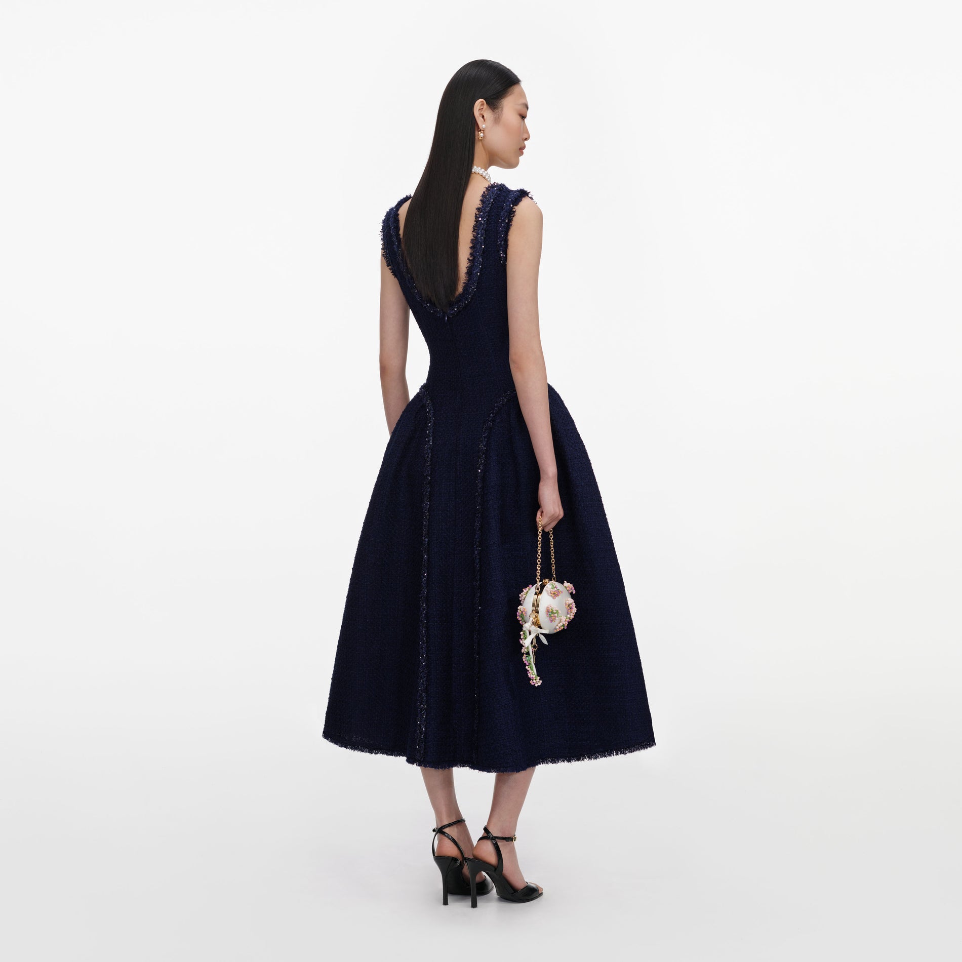 Back view of a woman wearing the Navy Boucle Midi Dress