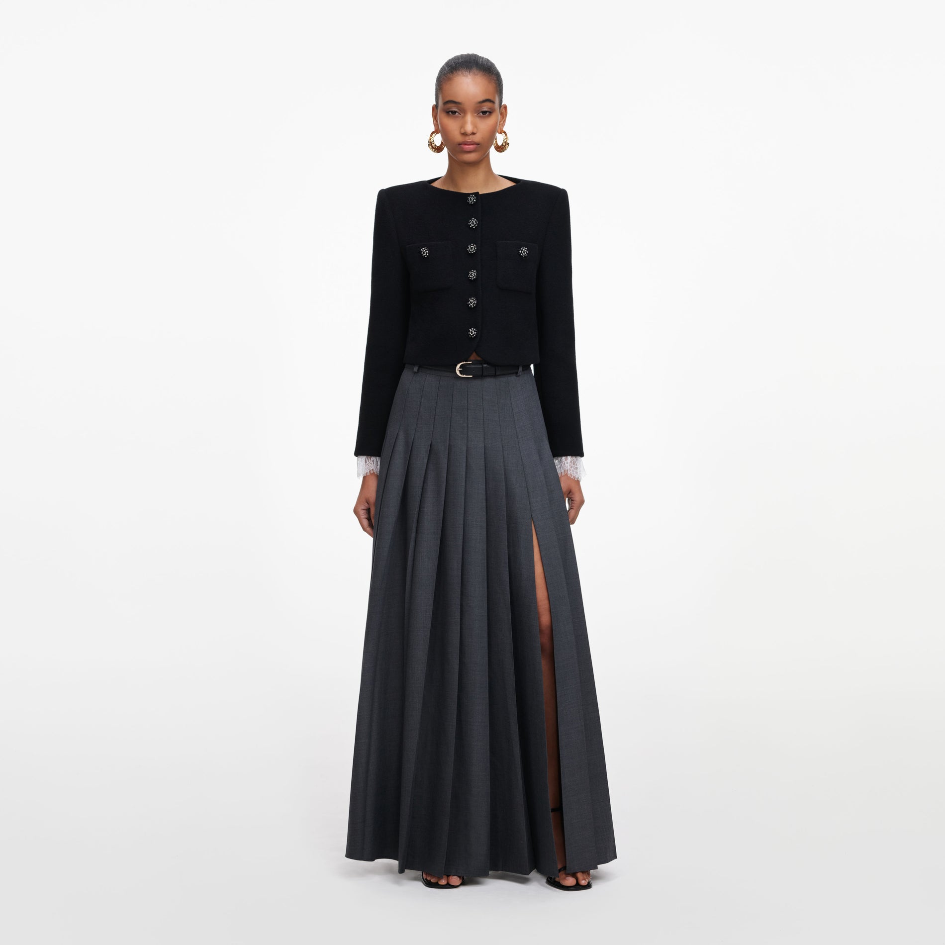 Front view of a woman wearing the Grey Pleated Maxi Skirt