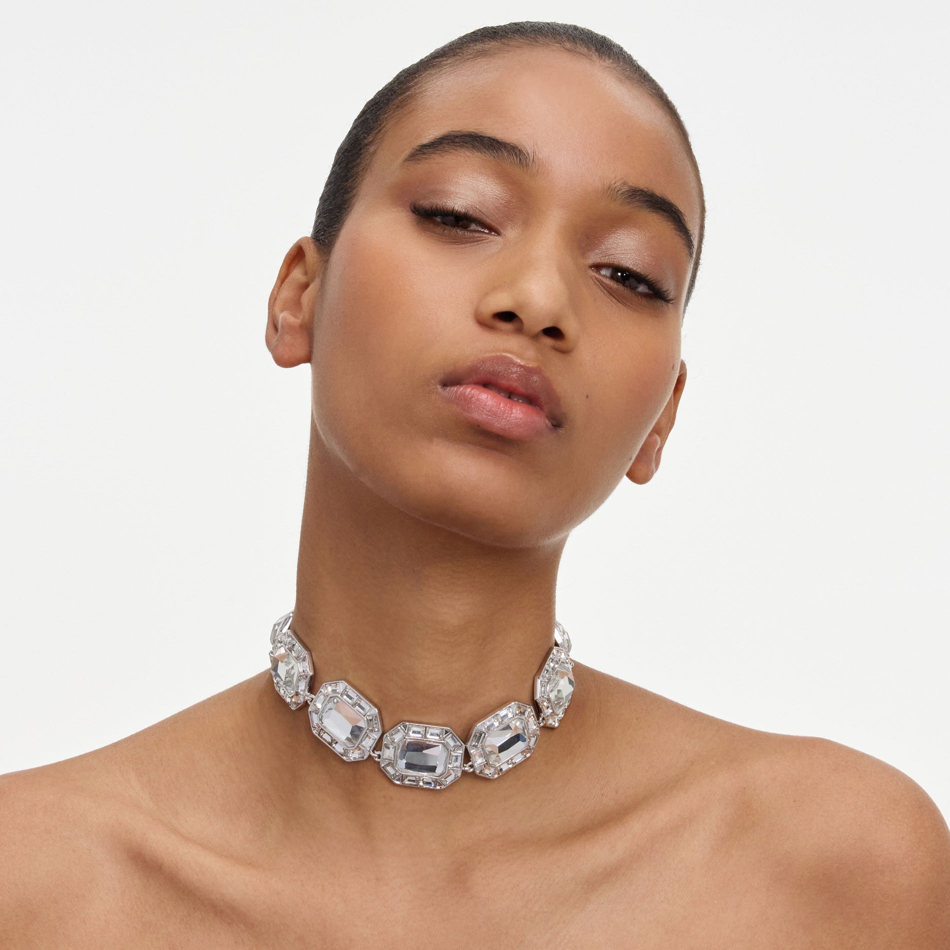A close up of a woman wearing the Silver Crystal Necklace